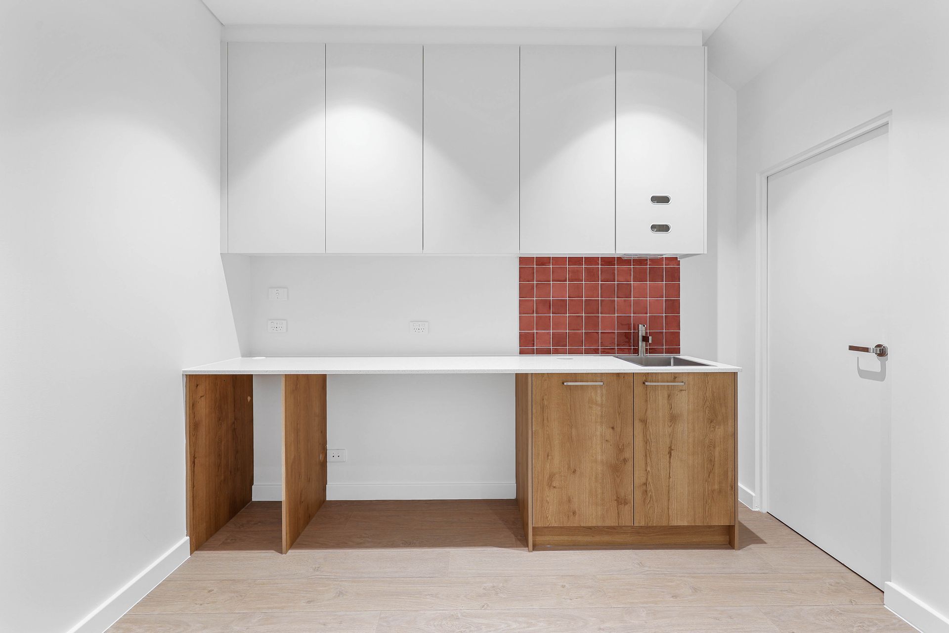 Minimal White Kitchen With Wood Cabinets — Above & Beyond Interiors in Smeaton Grange, NSW