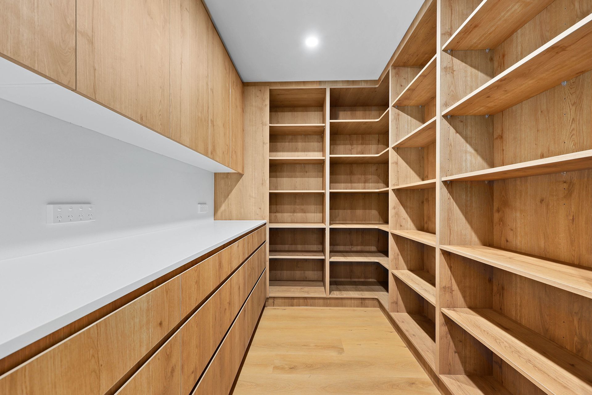 Walk-In Closet with Wood Shelves — Above & Beyond Interiors in Smeaton Grange, NSW