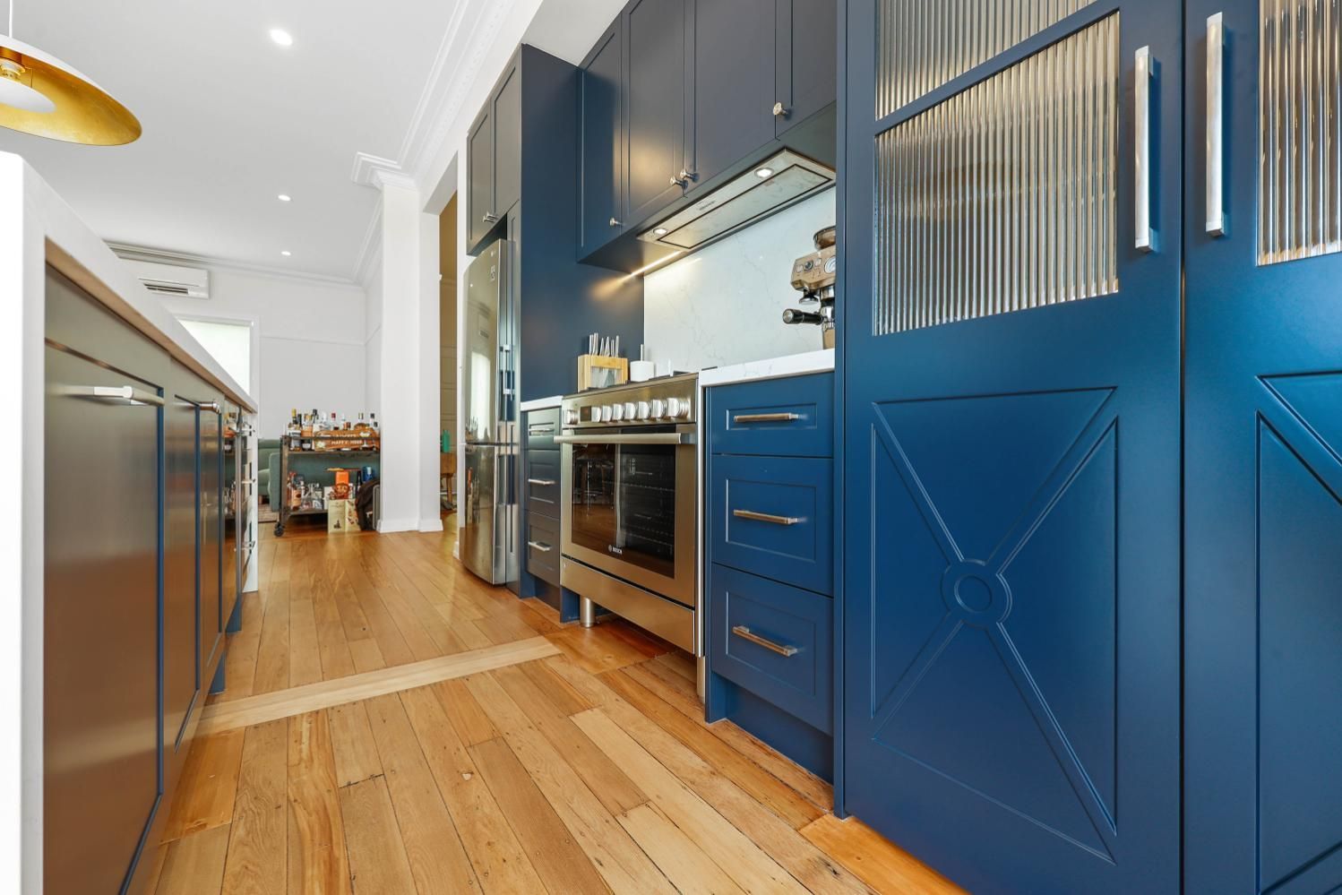 Modern Kitchen With Blue Cabinets, Wood Floors — Above & Beyond Interiors in Smeaton Grange, NSW