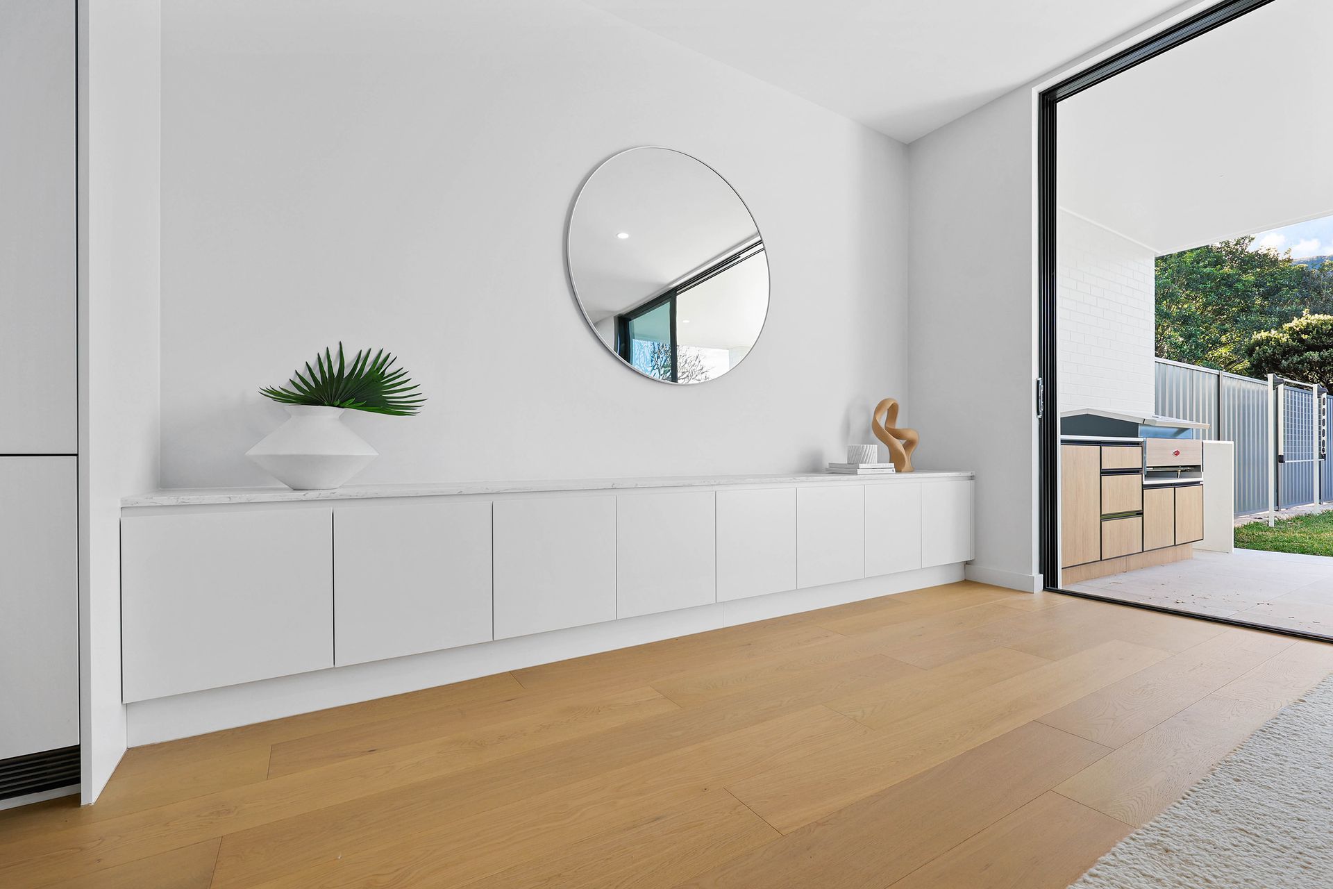 Minimal White Hallway With Built-in Cabinets — Above & Beyond Interiors in Smeaton Grange, NSW
