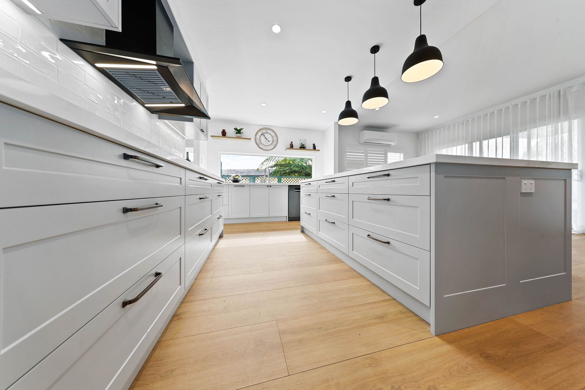 Bright Modern Kitchen Wit Pendant Lights, and A Light Wood Floor — Above & Beyond Interiors in Smeaton Grange, NSW