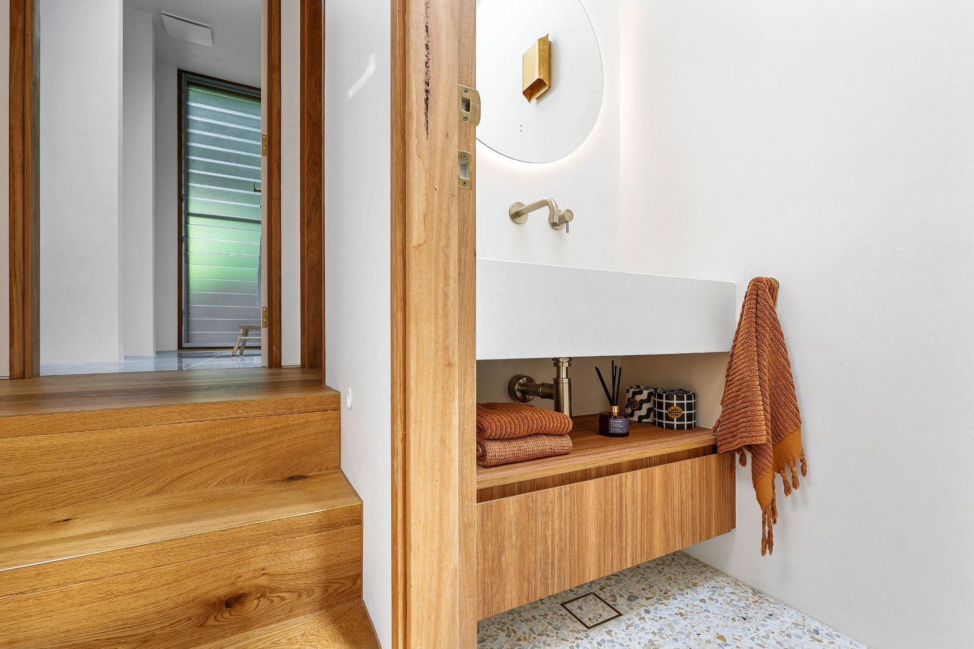 Modern Bathroom Vanity Beside Wooden Stairs — Above & Beyond Interiors in Smeaton Grange, NSW