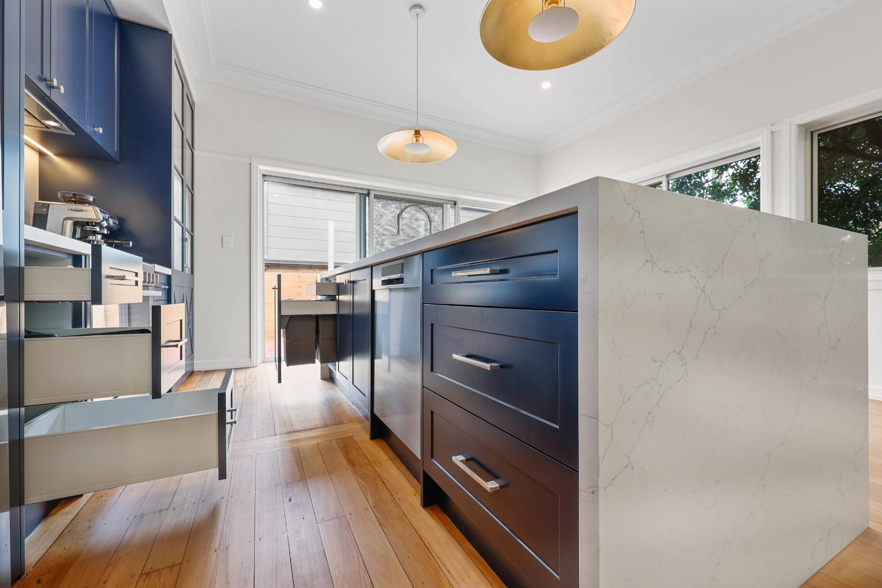 Modern Kitchen With Dark Cabinetry, White Island, and Pendant Lights — Above & Beyond Interiors in Smeaton Grange, NSW