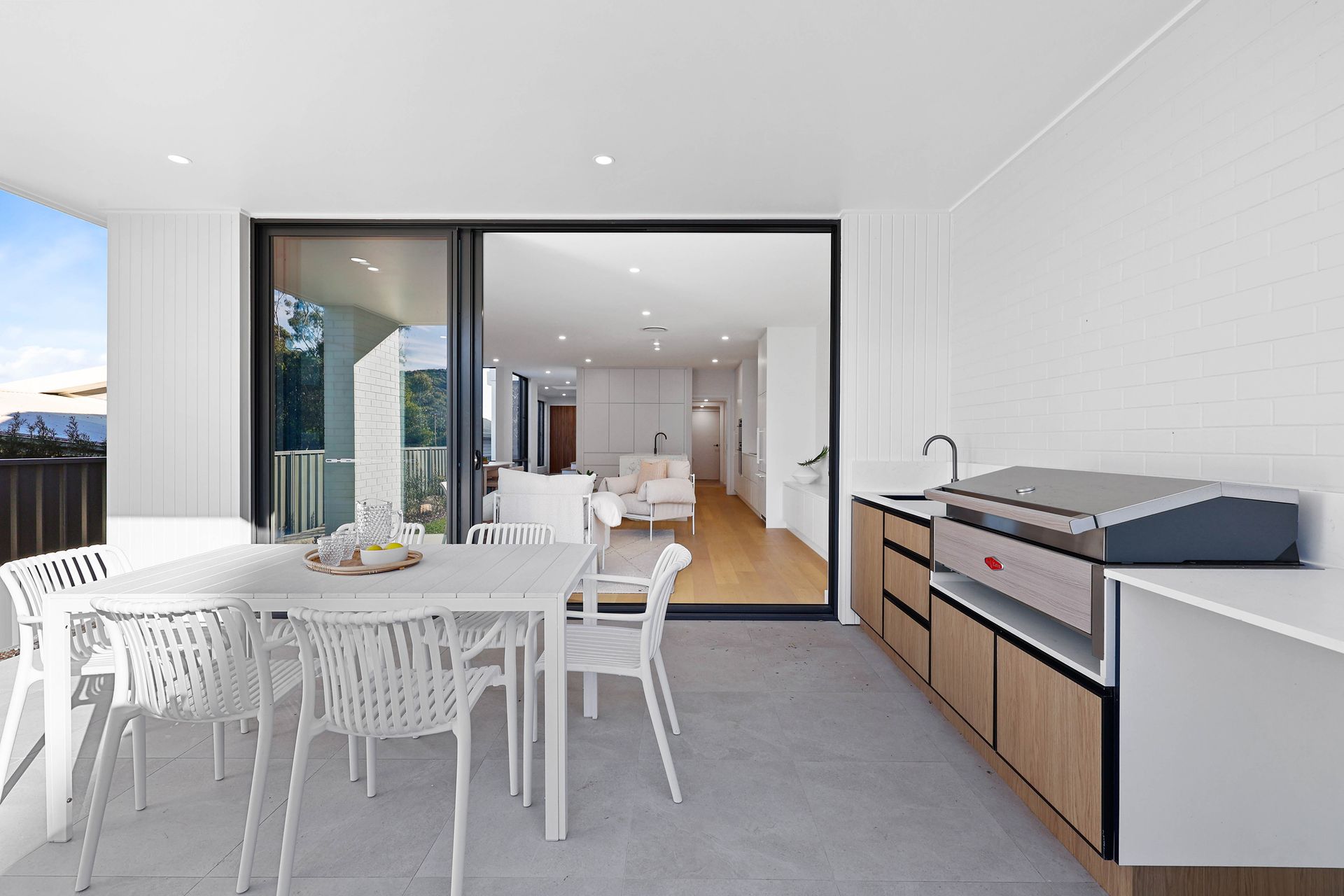 Bright Modern Dining Area With White Table and Chairs — Above & Beyond Interiors in Smeaton Grange, NSW