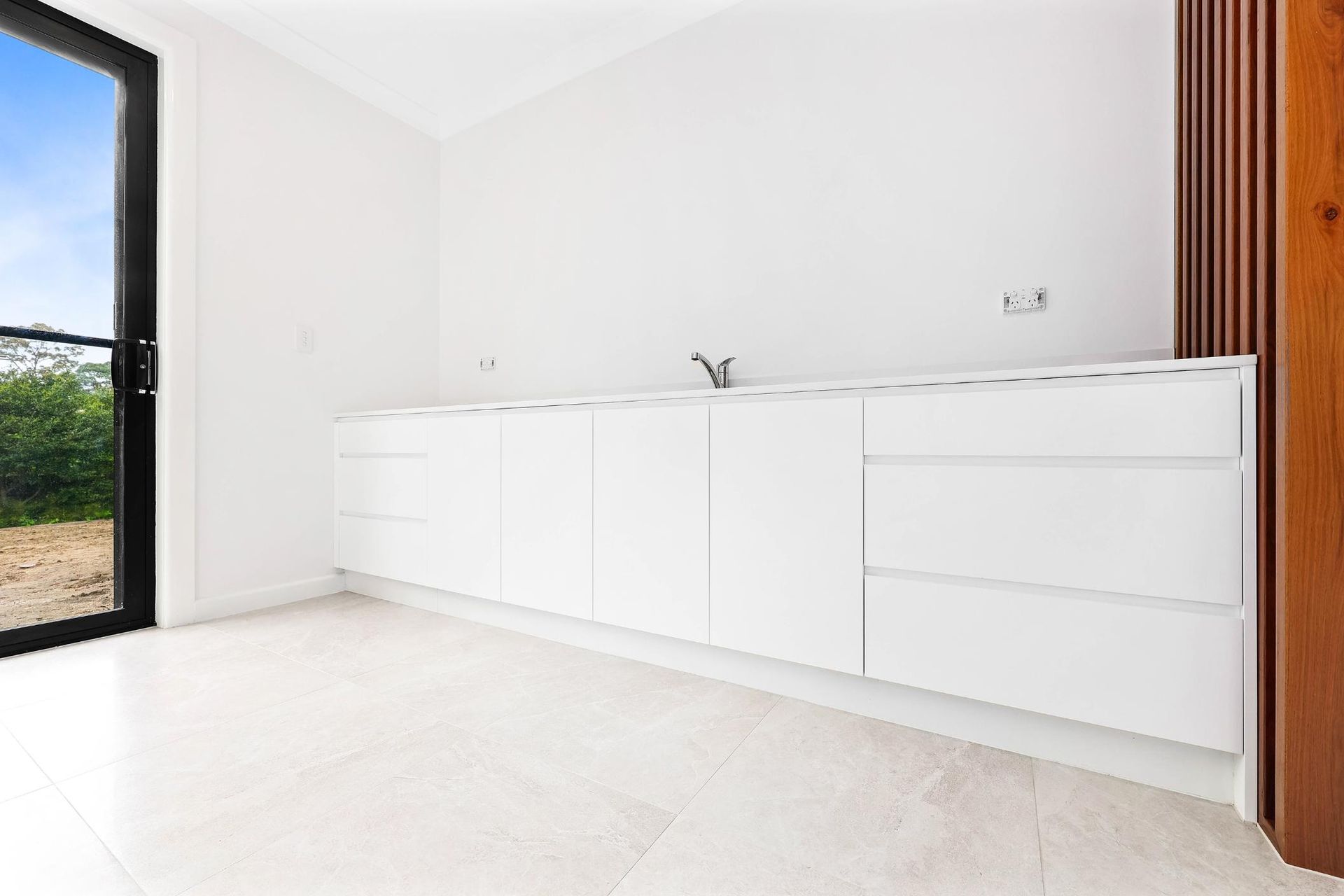 Modern White Kitchen with Long Cabinets — Above & Beyond Interiors in Smeaton Grange, NSW