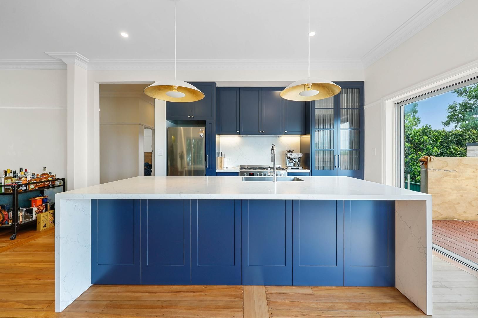 Modern Kitchen With Blue Island Cabinetry — Above & Beyond Interiors in Smeaton Grange, NSW