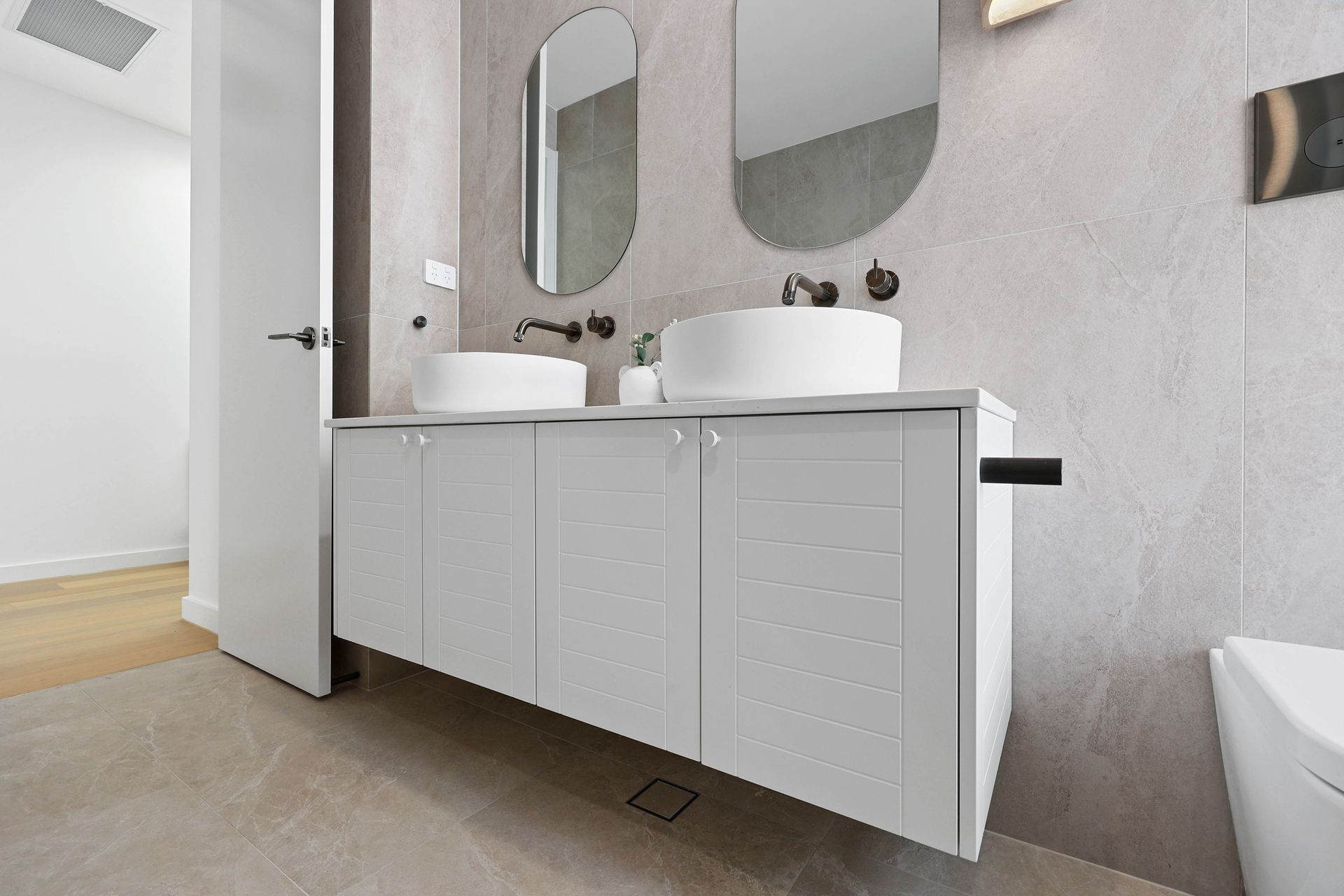 Modern Bathroom With Double Vanity, Oval Mirrors — Above & Beyond Interiors in Smeaton Grange, NSW