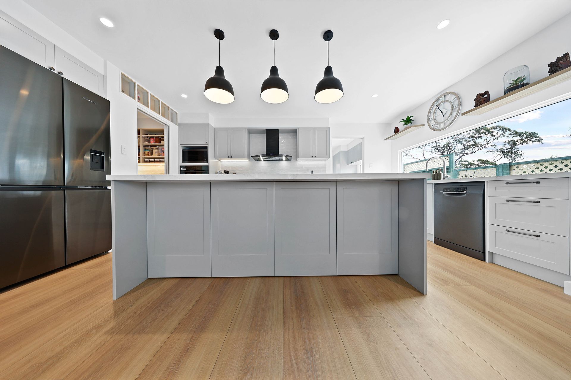 Modern White Kitchen with Black and Pendant Lights — Above & Beyond Interiors in Smeaton Grange, NSW