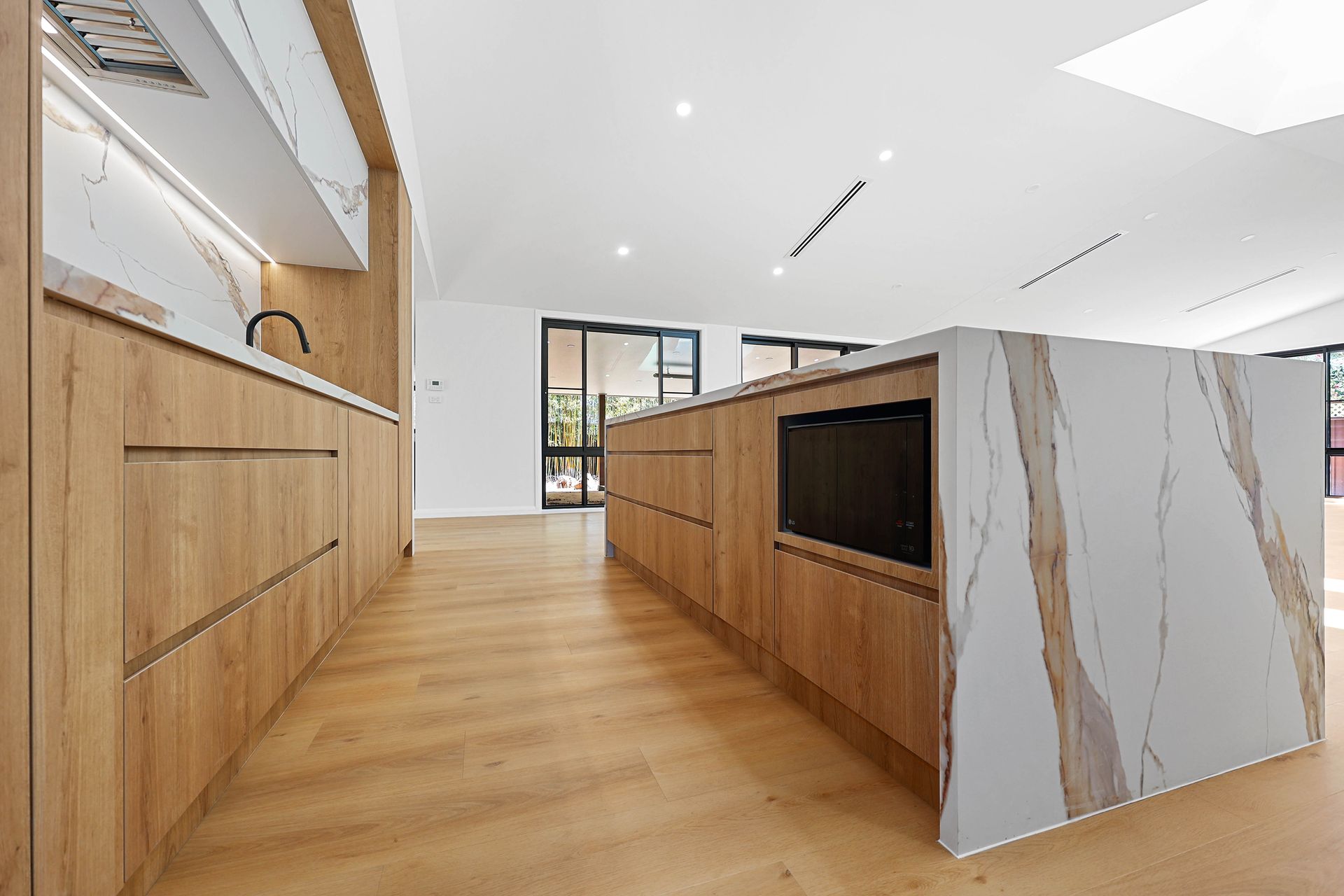 Modern Kitchen with Light Wood Cabinets — Above & Beyond Interiors in Smeaton Grange, NSW