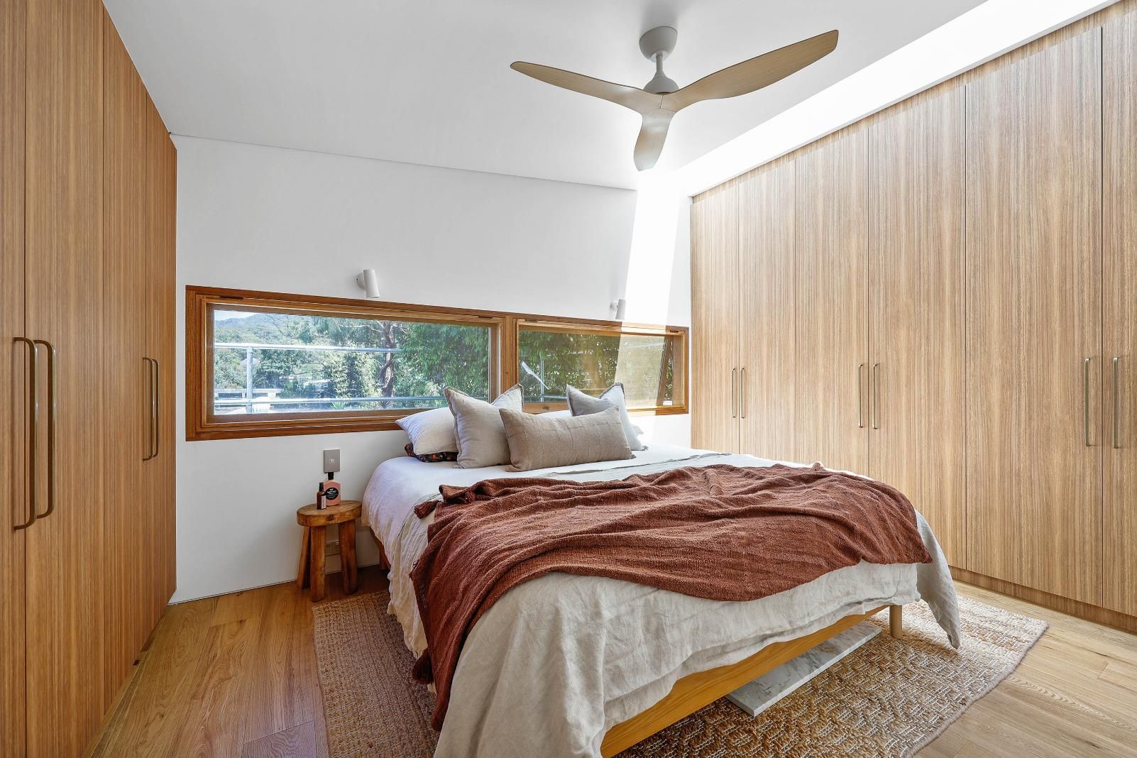 Modern Bedroom With Wooden Wardrobes — Above & Beyond Interiors in Smeaton Grange, NSW