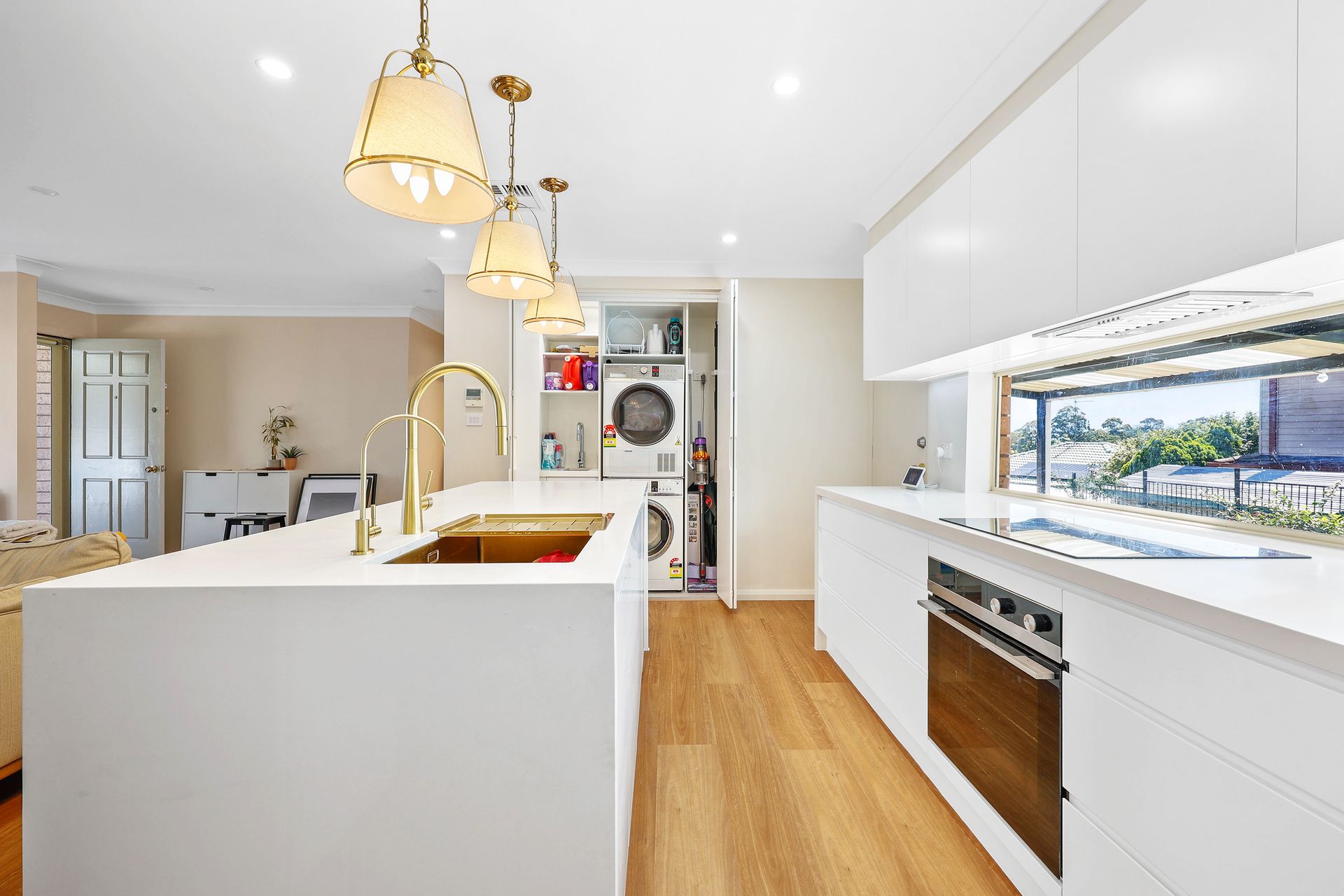 Bright White Kitchen With Island, Pendant Lights — Above & Beyond Interiors in Smeaton Grange, NSW