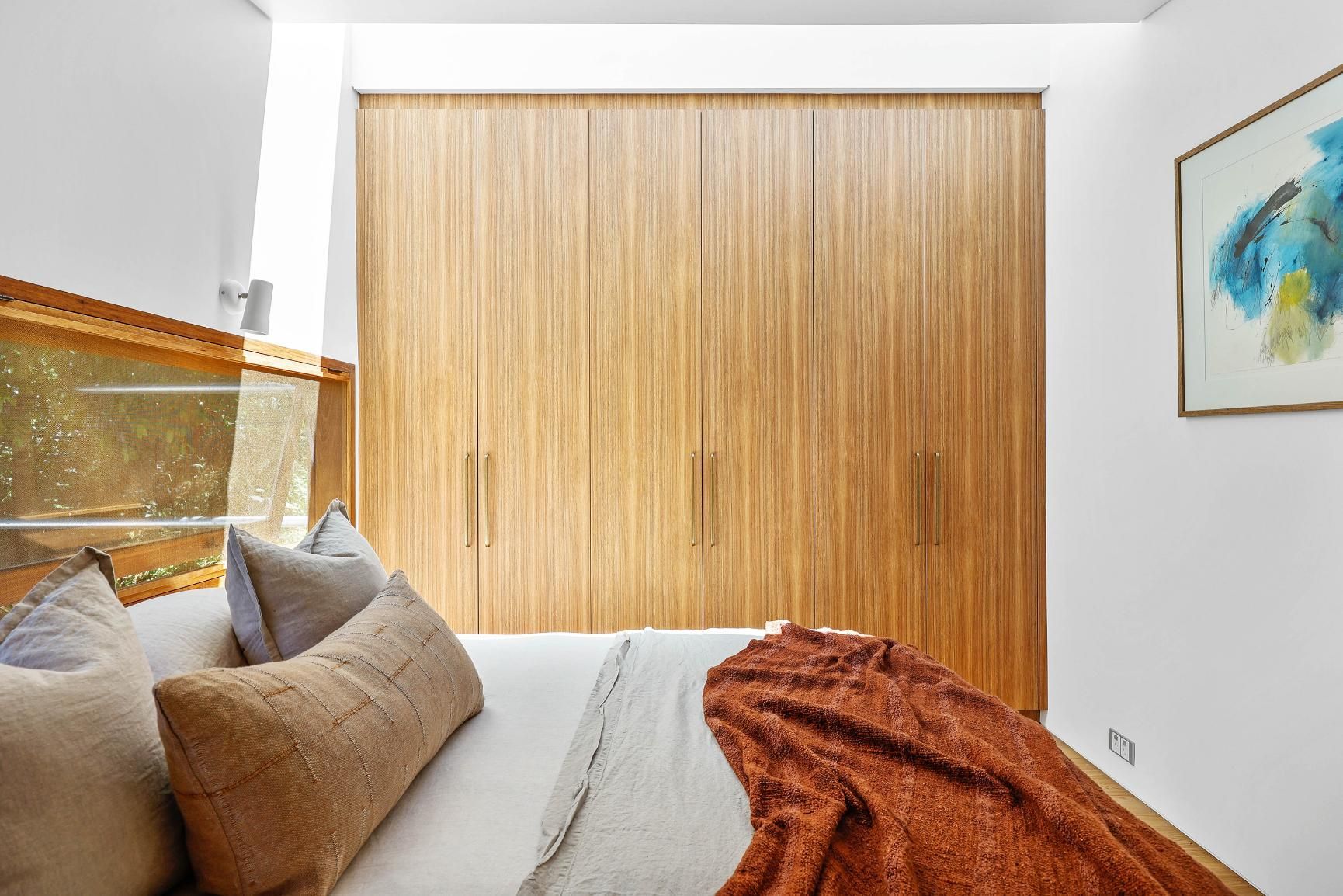 Bedroom With Beige Bedding, Rust Throw Blanket — Above & Beyond Interiors in Smeaton Grange, NSW