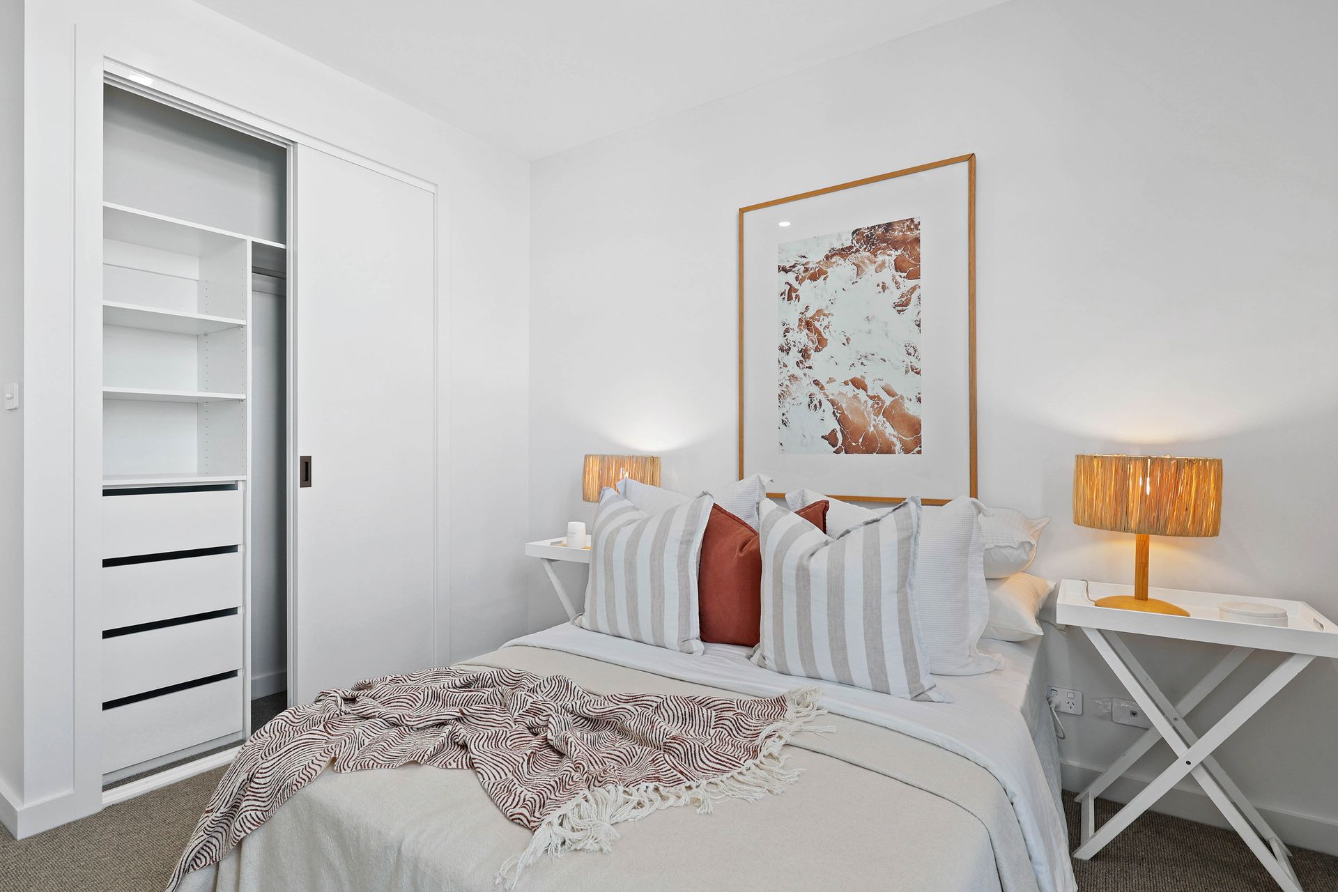 Bright White Bedroom With a Neatly Made Bed, Framed Wall Art — Above & Beyond Interiors in Smeaton Grange, NSW
