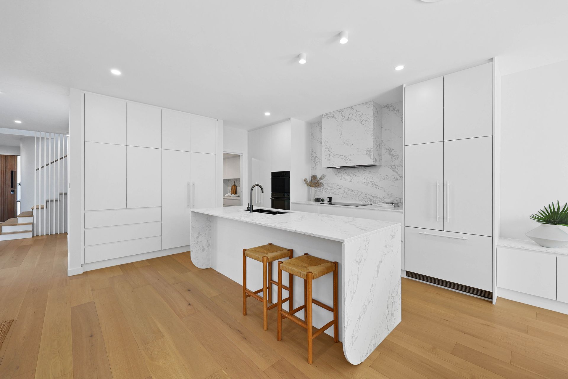 Bright White Modern Kitchen With Marble Island — Above & Beyond Interiors in Smeaton Grange, NSW