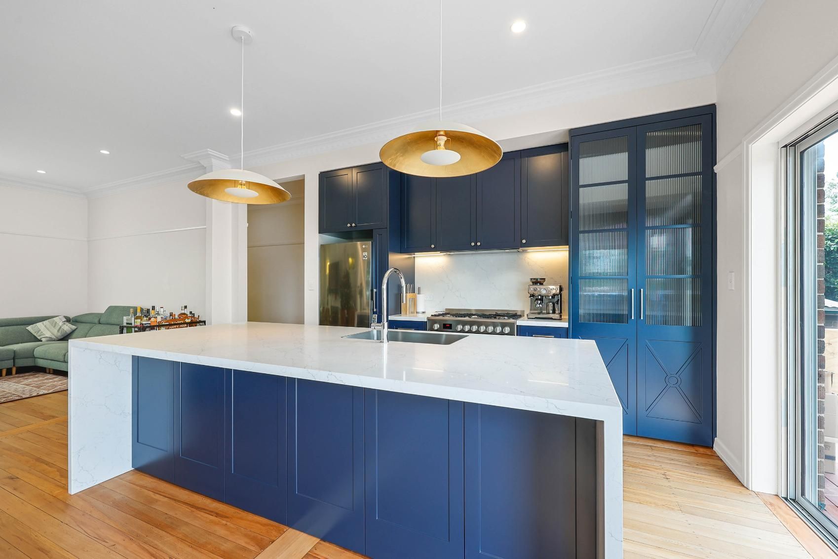 Bright Modern Kitchen With Blue Cabinets — Above & Beyond Interiors in Smeaton Grange, NSW
