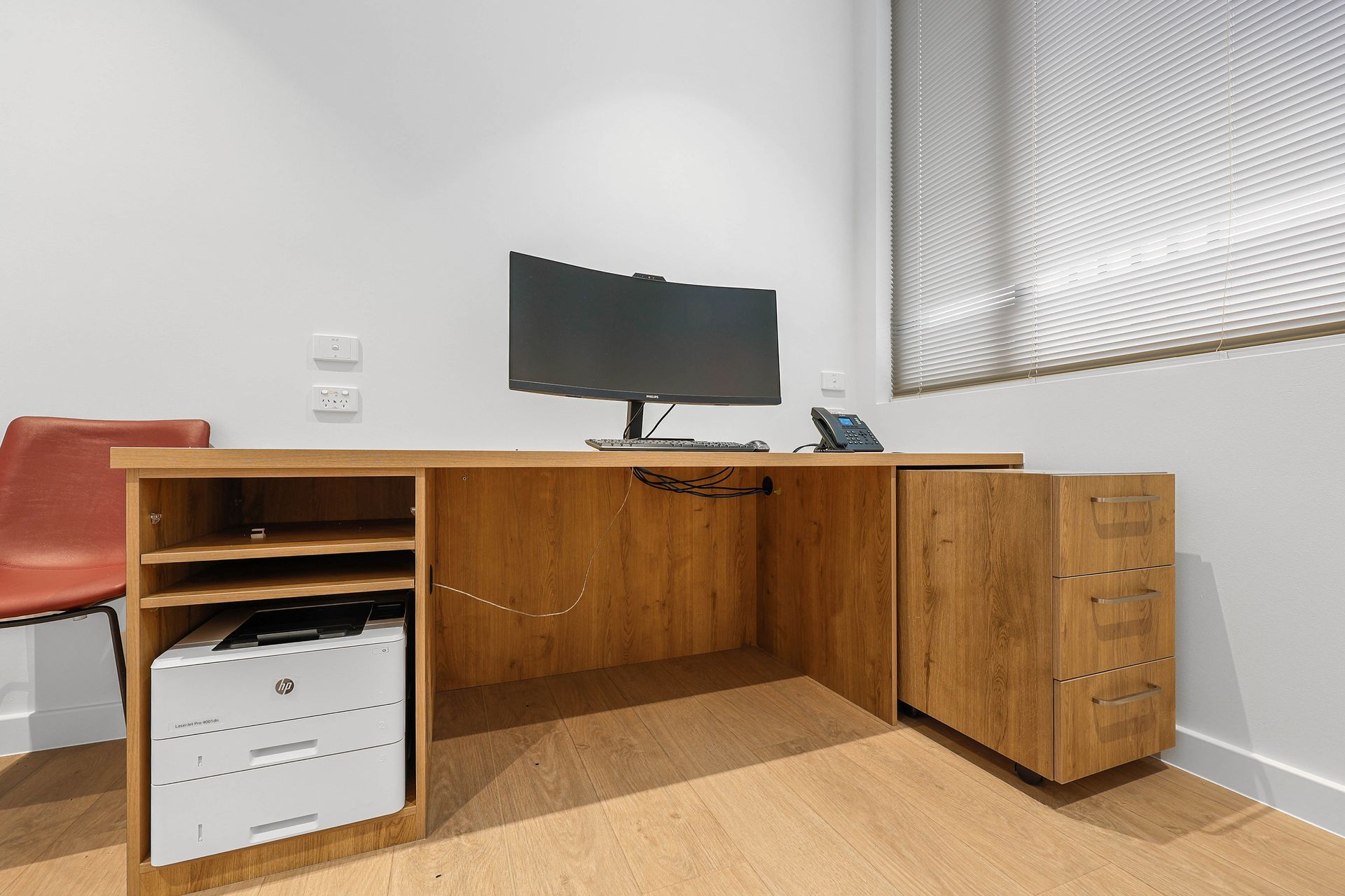 Wooden Desk With Monitor in a Sparse Office — Above & Beyond Interiors in Smeaton Grange, NSW