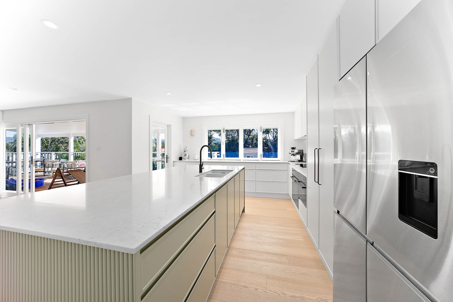 Modern White Kitchen With a Large Island — Above & Beyond Interiors in Smeaton Grange, NSW