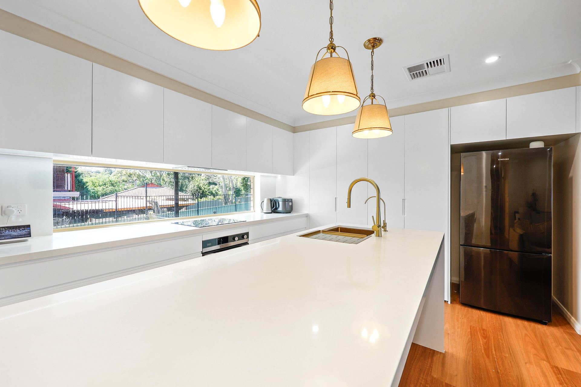 Bright Modern Kitchen With White Island, Pendant Lights — Above & Beyond Interiors in Smeaton Grange, NSW