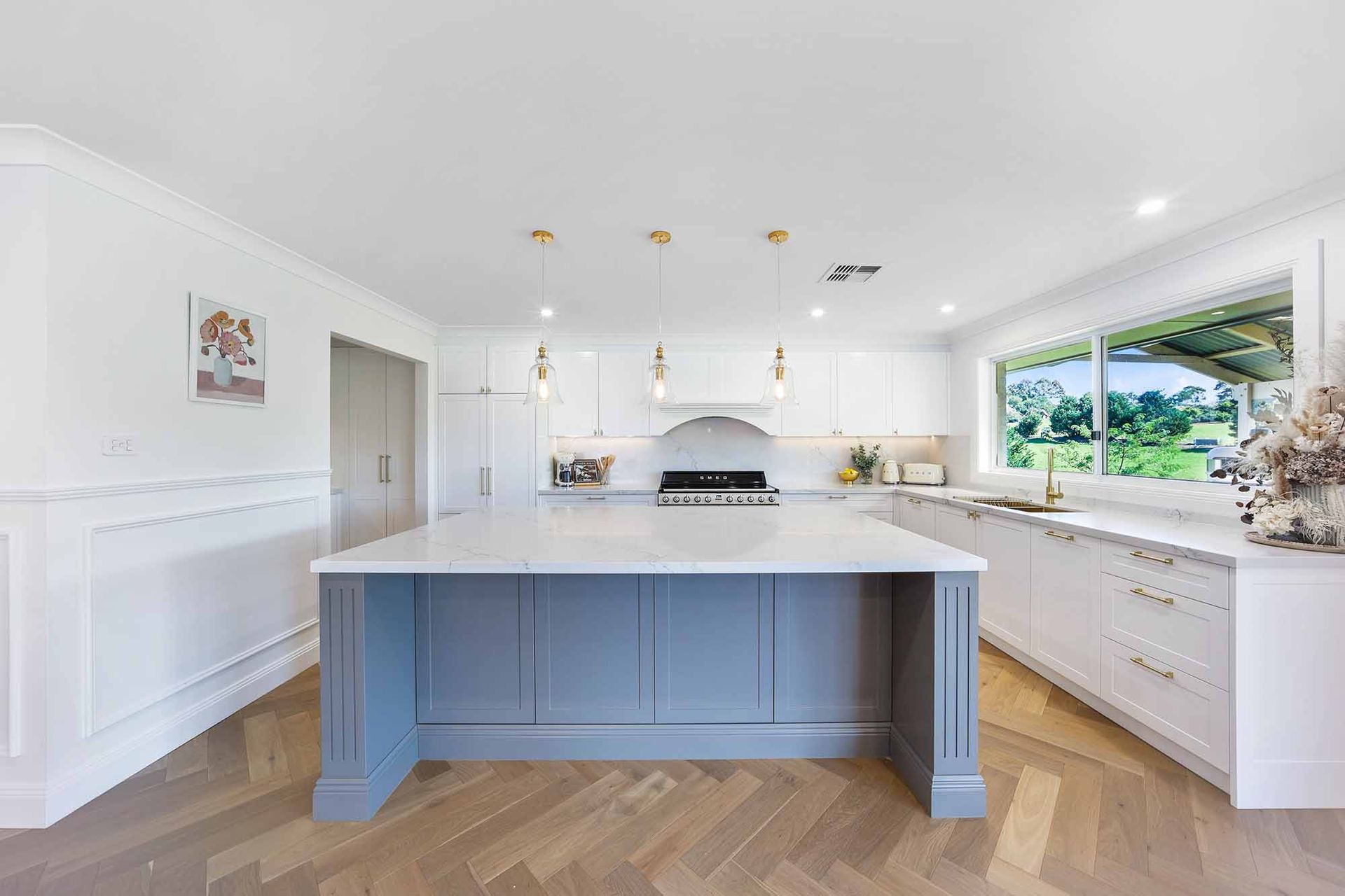 Bright White Kitchen With a Large Blue Island — Above & Beyond Interiors in Smeaton Grange, NSW