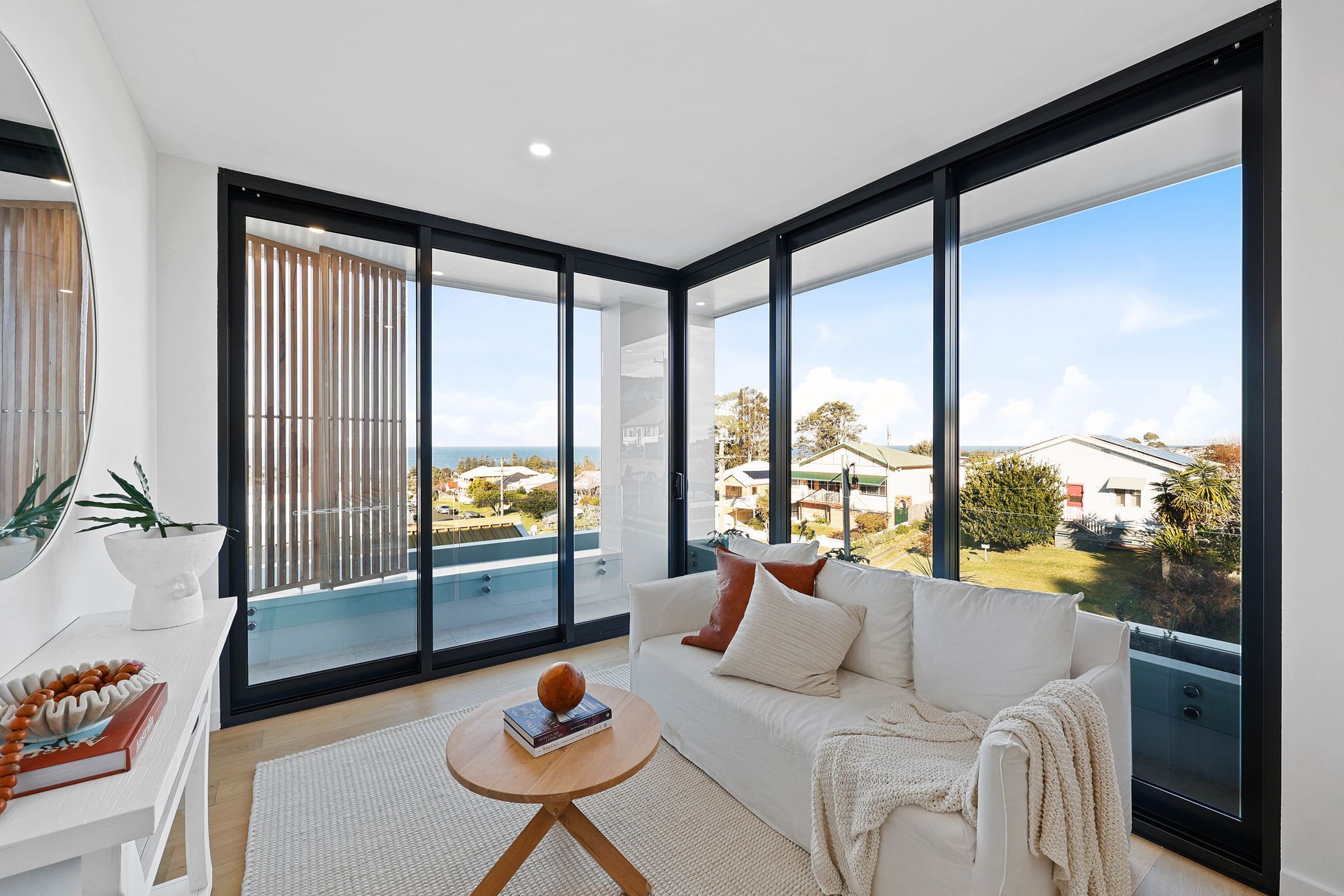 Bright Corner Living Room With White Sofa — Above & Beyond Interiors in Smeaton Grange, NSW
