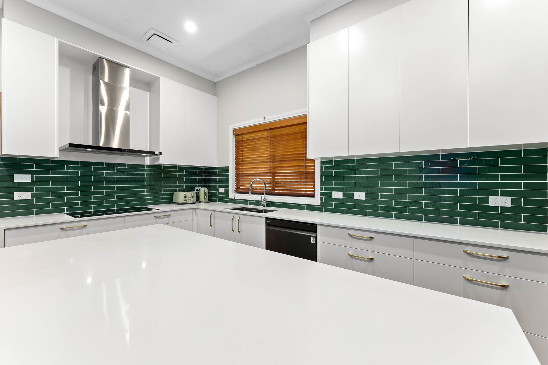 Modern Kitchen with White Cabinets, Green Tile Backsplash — Above & Beyond Interiors in Smeaton Grange, NSW