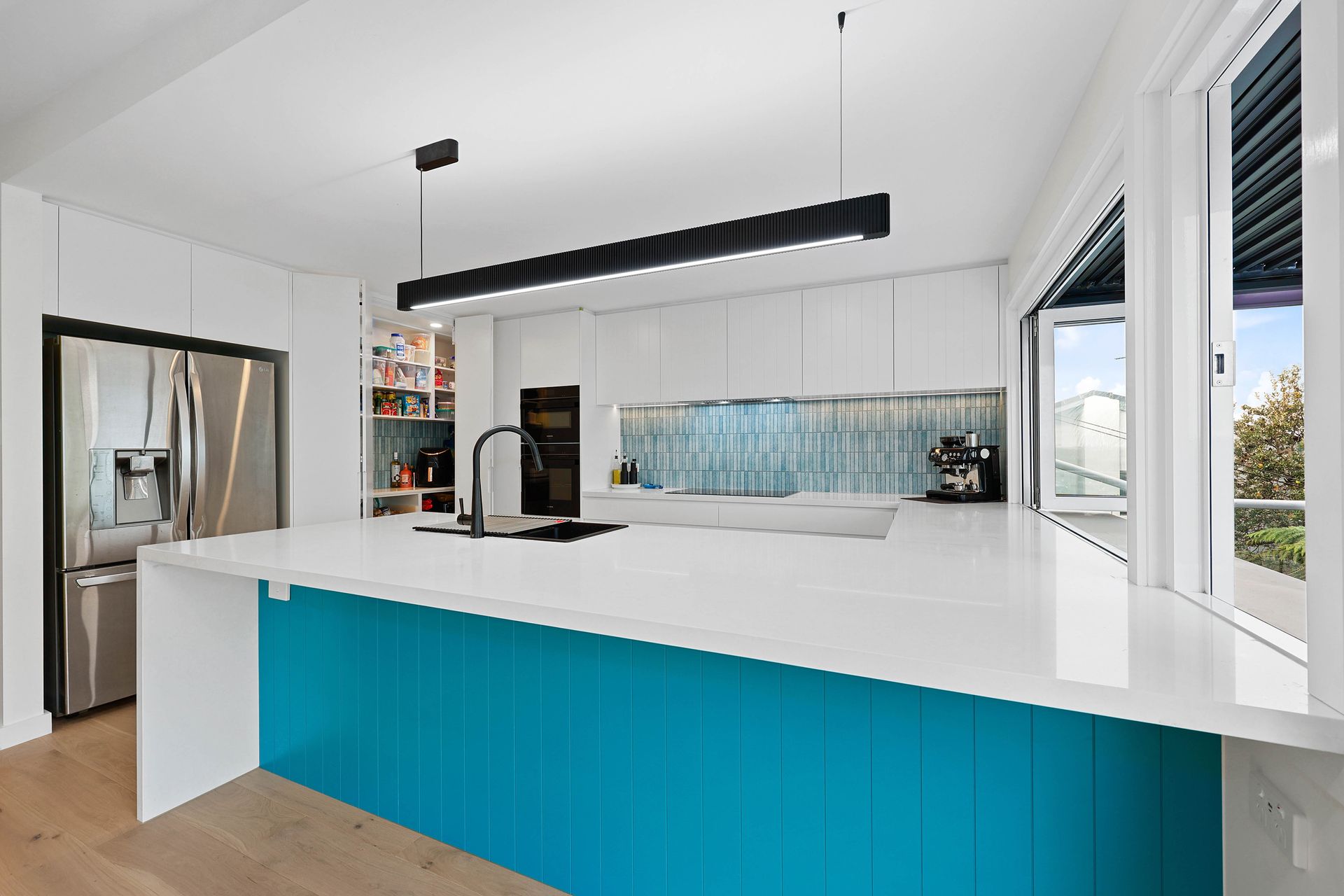 Modern Kitchen with Bright Blue Front Panel — Above & Beyond Interiors in Smeaton Grange, NSW