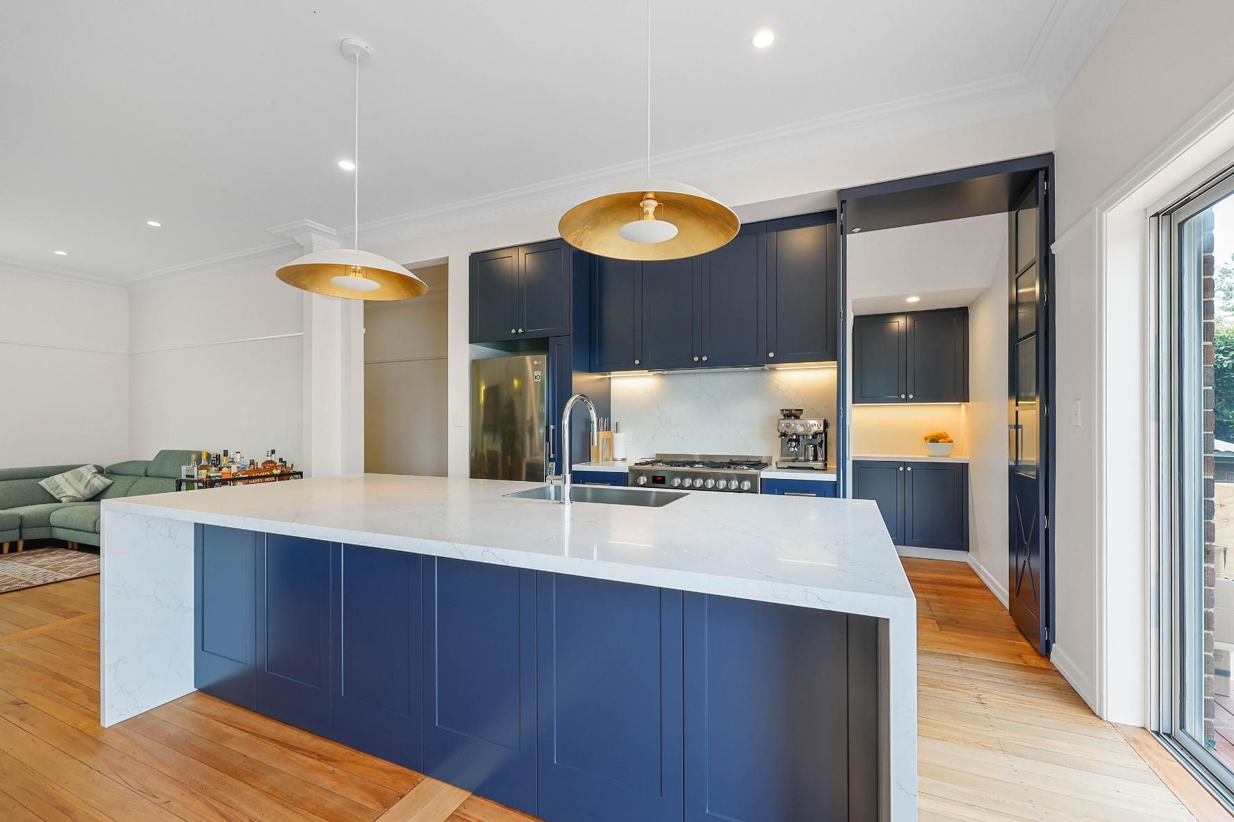 Modern Kitchen With Blue Island Cabinets — Above & Beyond Interiors in Smeaton Grange, NSW