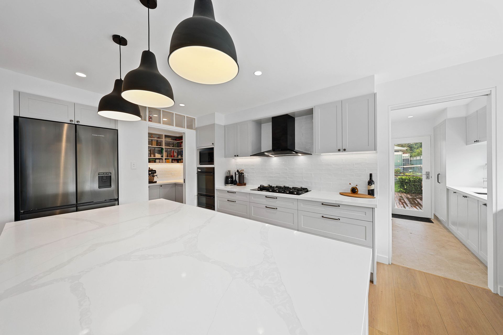 Bright Modern Kitchen with White Marble Island — Above & Beyond Interiors in Smeaton Grange, NSW