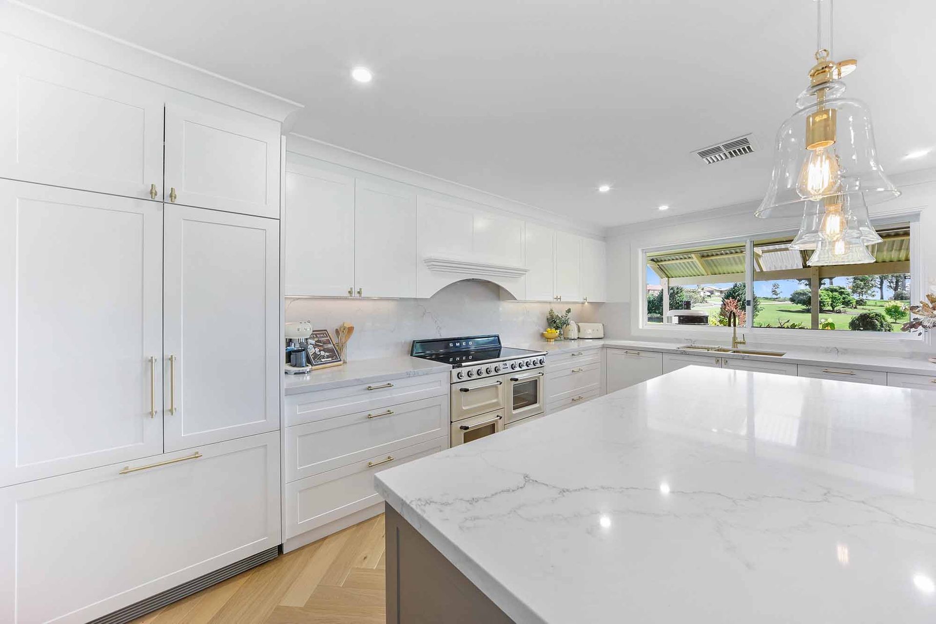 Bright White Modern Kitchen With Marble Island — Above & Beyond Interiors in Smeaton Grange, NSW