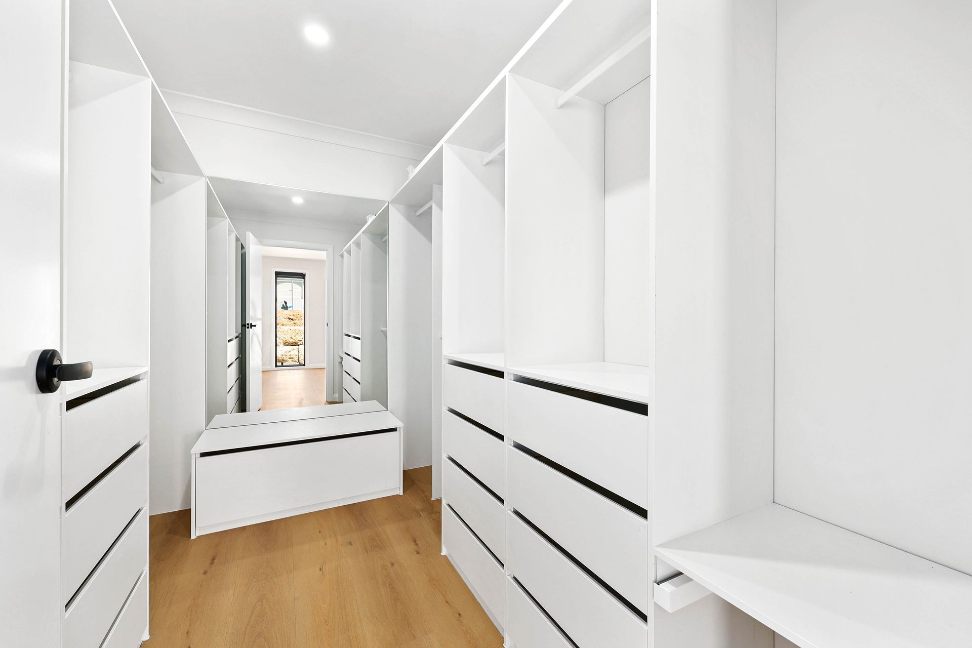 Bright White Walk-In Closet with Built-In Shelves — Above & Beyond Interiors in Smeaton Grange, NSW