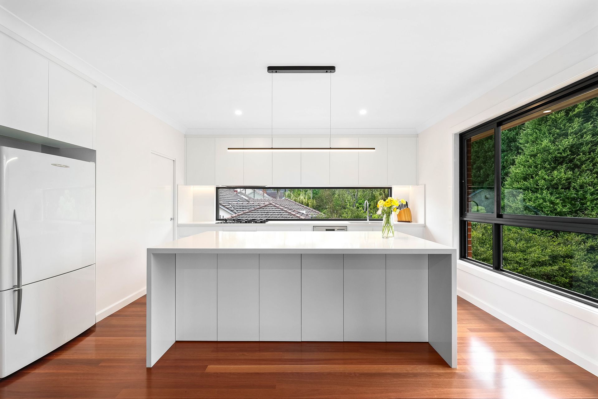 Bright Modern Kitchen with White Cabinets — Above & Beyond Interiors in Smeaton Grange, NSW