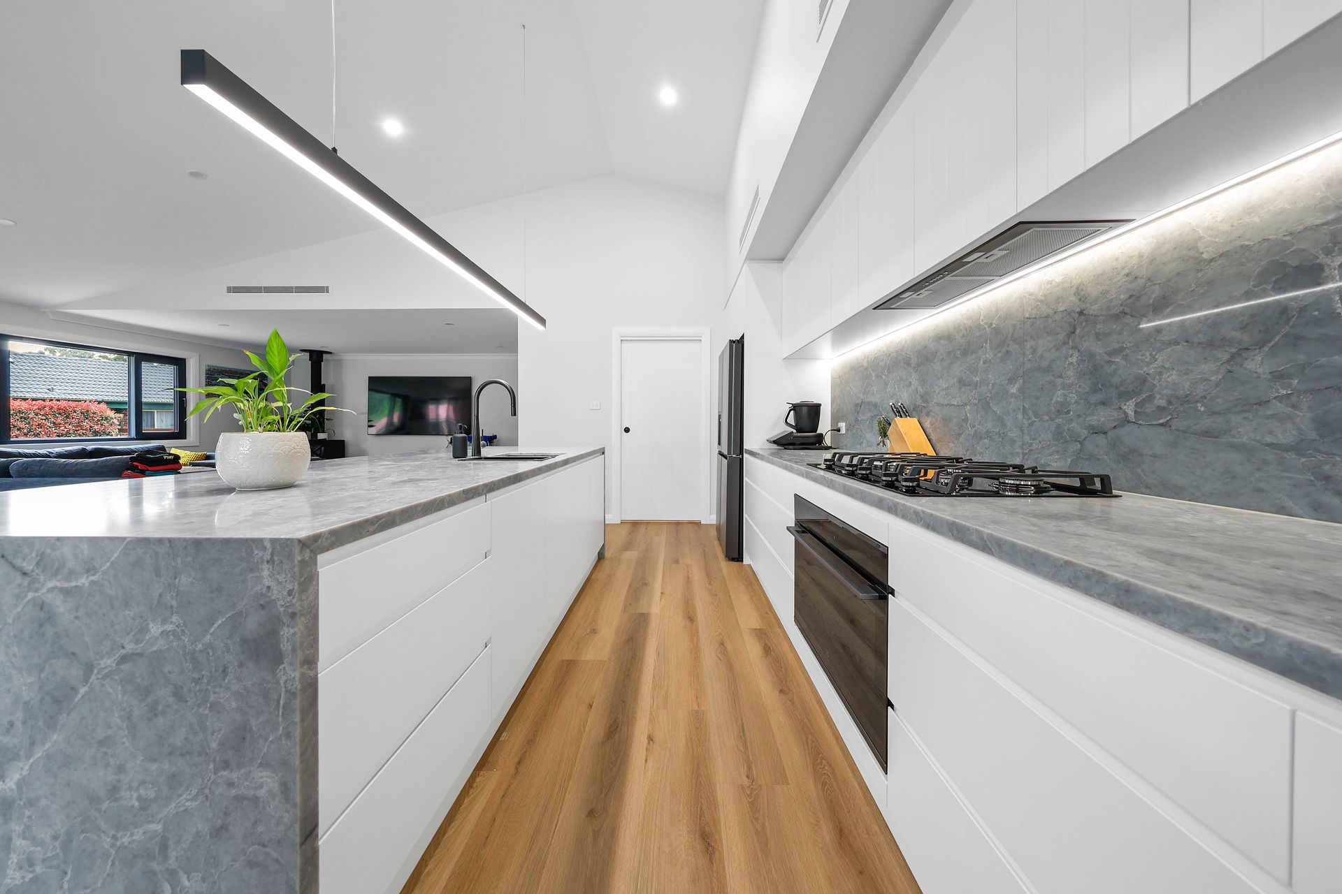 Modern White Kitchen With Marble Countertops — Above & Beyond Interiors in Smeaton Grange, NSW