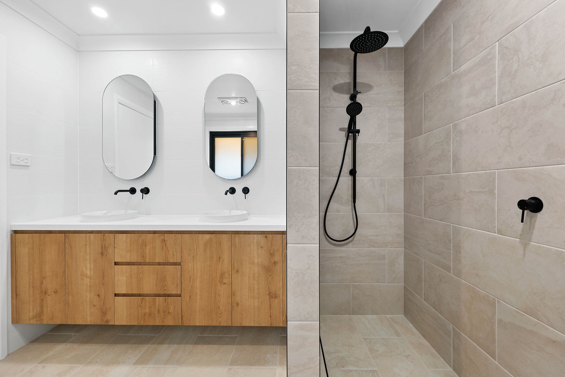 A Bathroom with Wood Vanity, Two Mirrors, and Tiled Walk-In Shower — Above & Beyond Interiors in Smeaton Grange, NSW