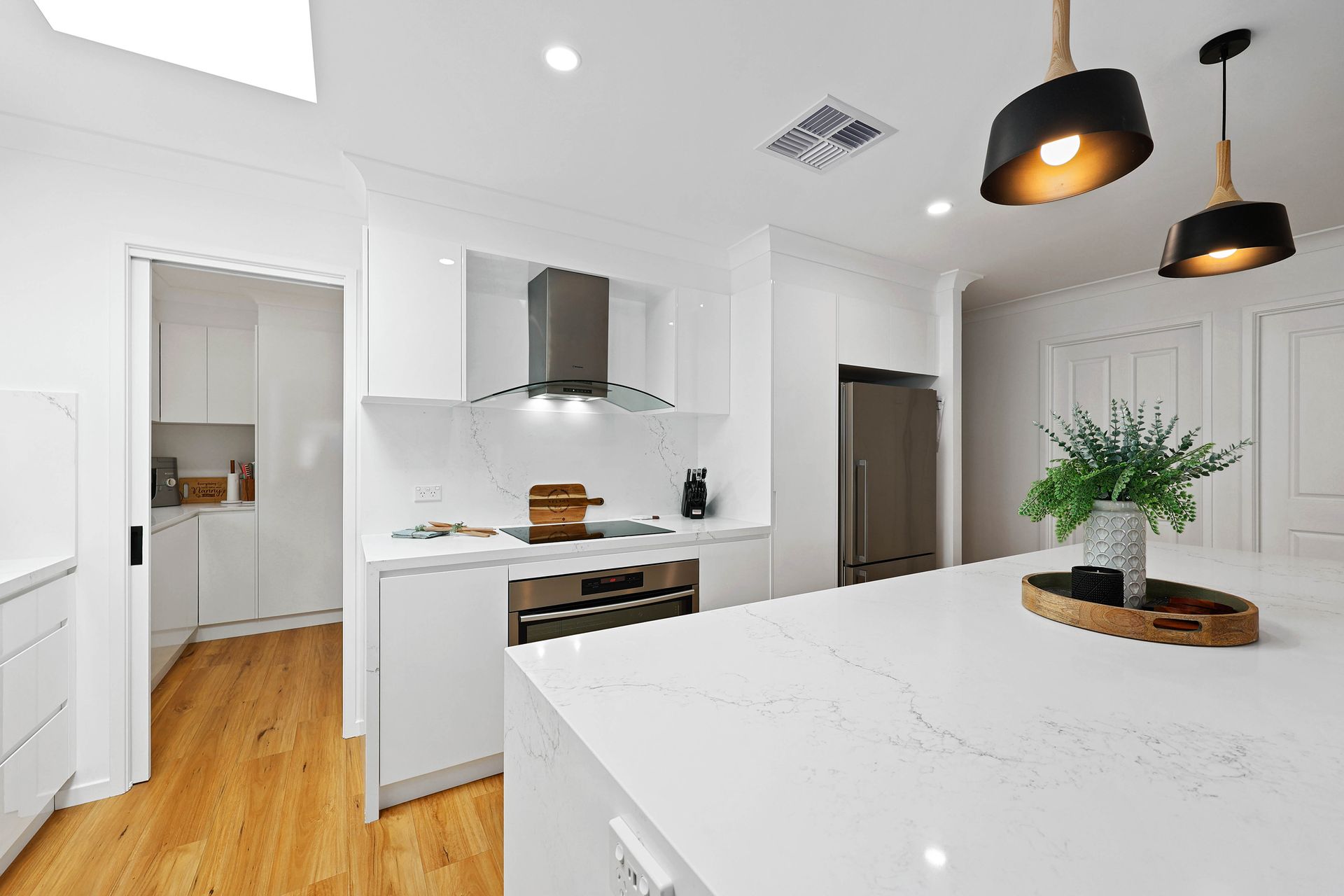 Bright Modern White Kitchen with Island — Above & Beyond Interiors in Smeaton Grange, NSW