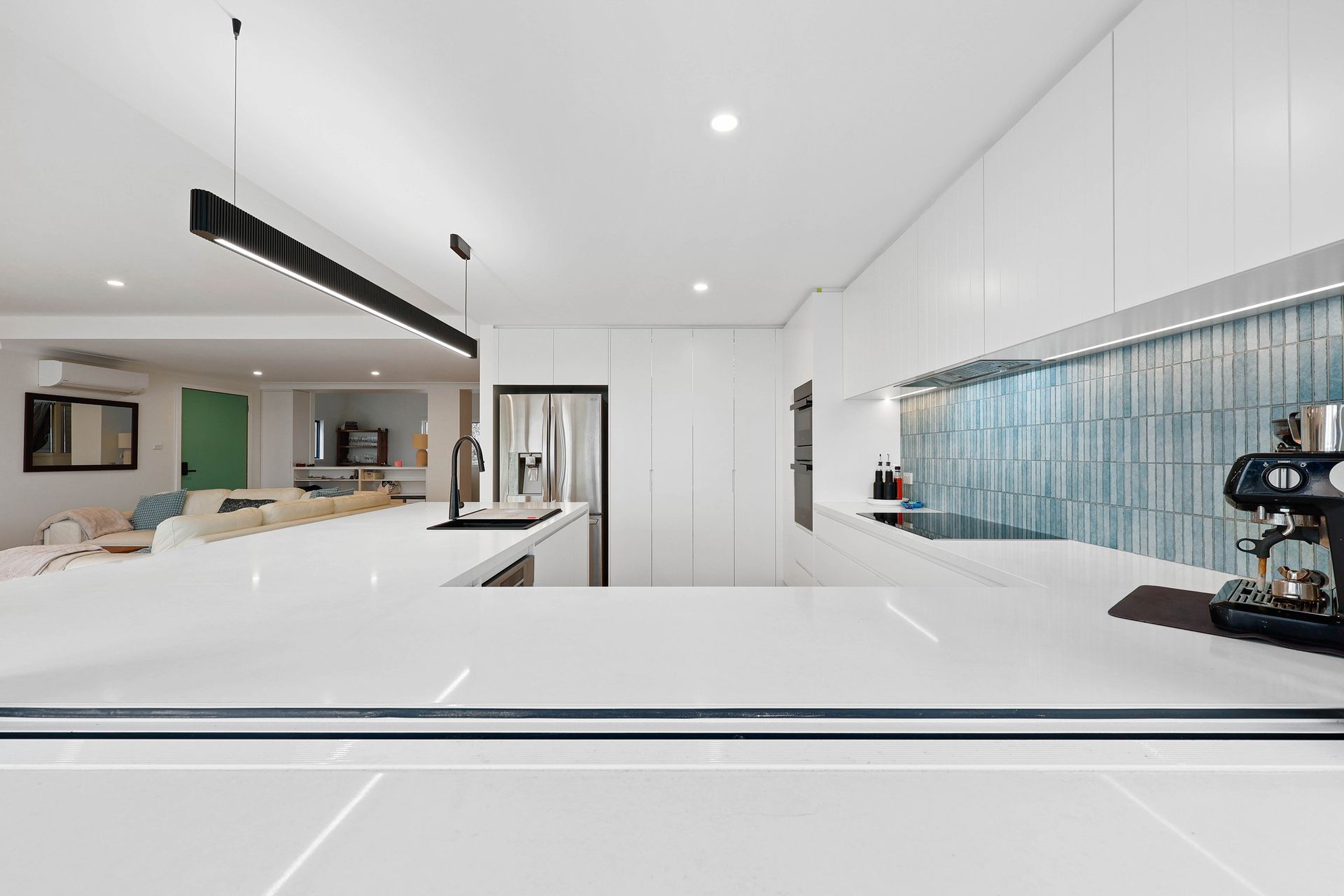 Bright Modern White Kitchen with Island — Above & Beyond Interiors in Smeaton Grange, NSW