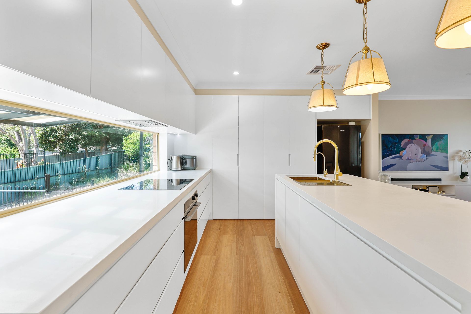 Modern White Kitchen With Wood Floors, Gold Pendant Lights — Above & Beyond Interiors in Smeaton Grange, NSW