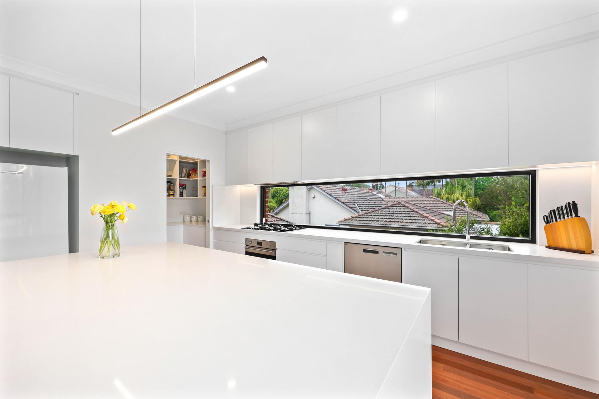Bright Modern White Kitchen with Large Island — Above & Beyond Interiors in Smeaton Grange, NSW