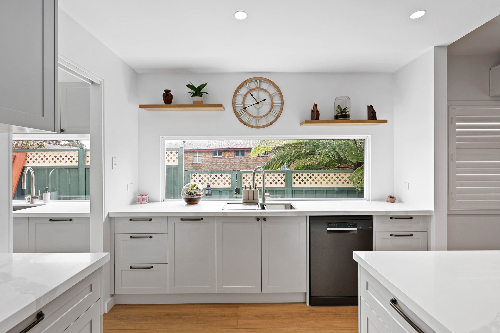 Bright White Modern Kitchen with Window Sink — Above & Beyond Interiors in Smeaton Grange, NSW