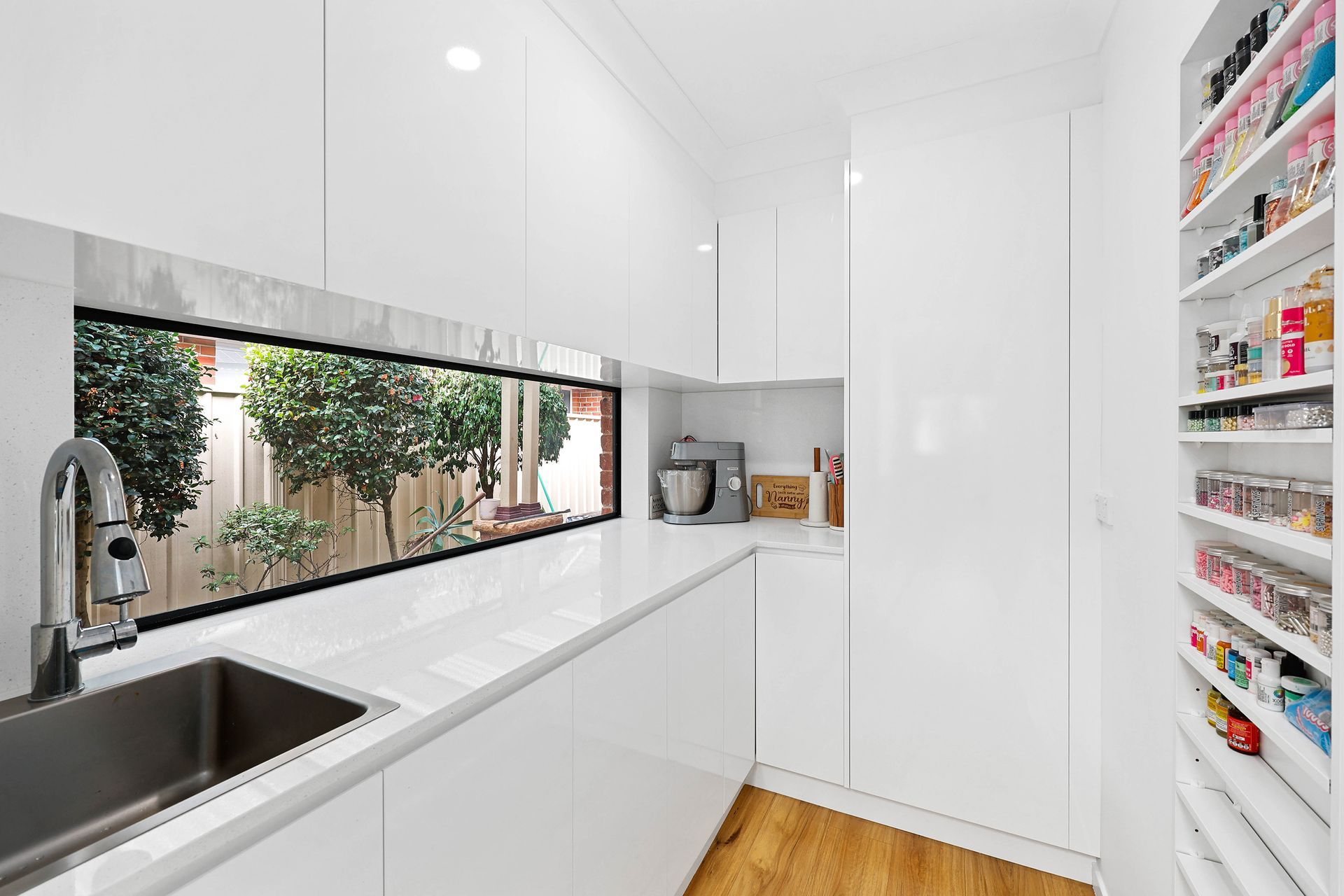 Bright White Galley Kitchen with Sink — Above & Beyond Interiors in Smeaton Grange, NSW