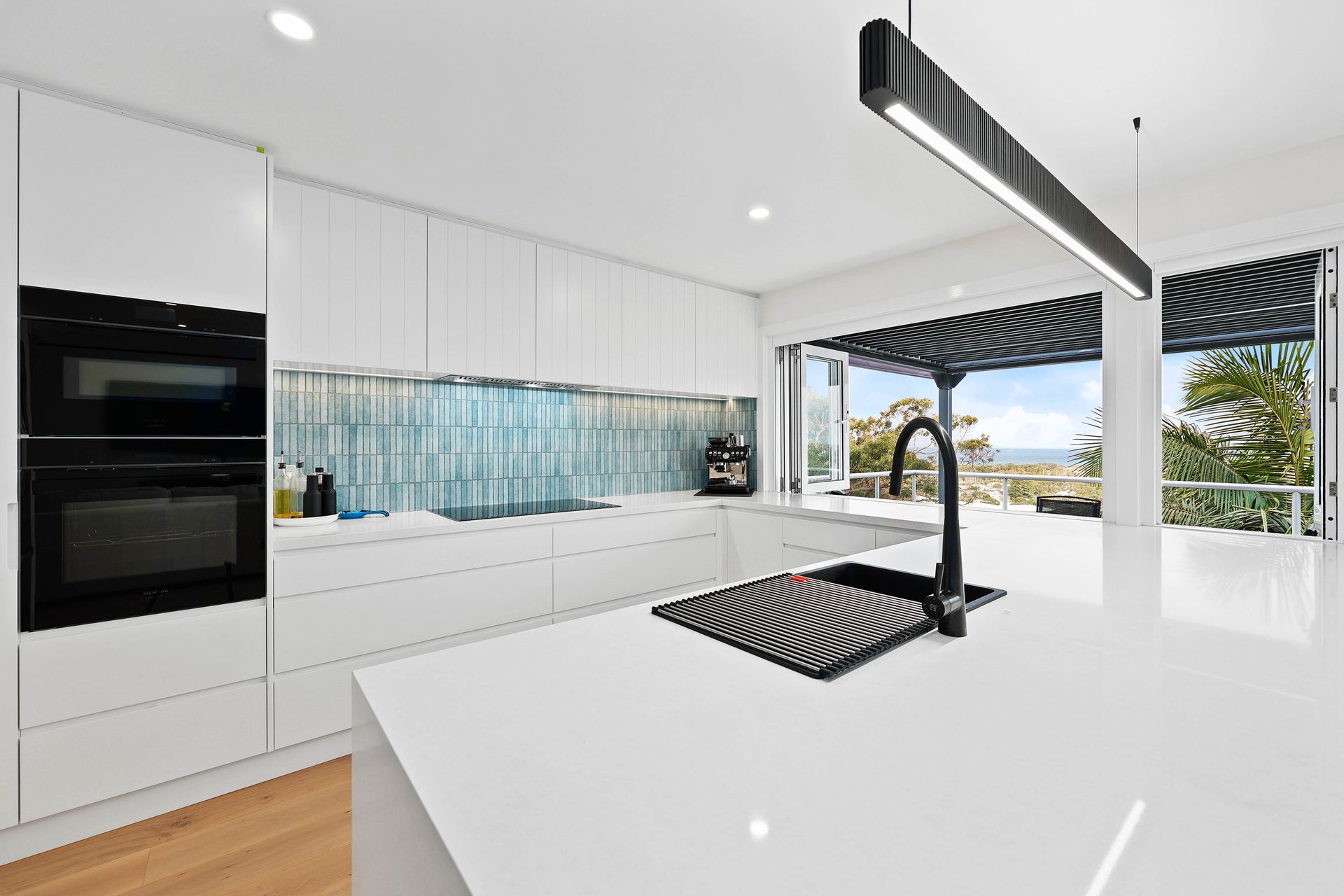 A Kitchen with Black Accents, and Large Windows — Above & Beyond Interiors in Smeaton Grange, NSW