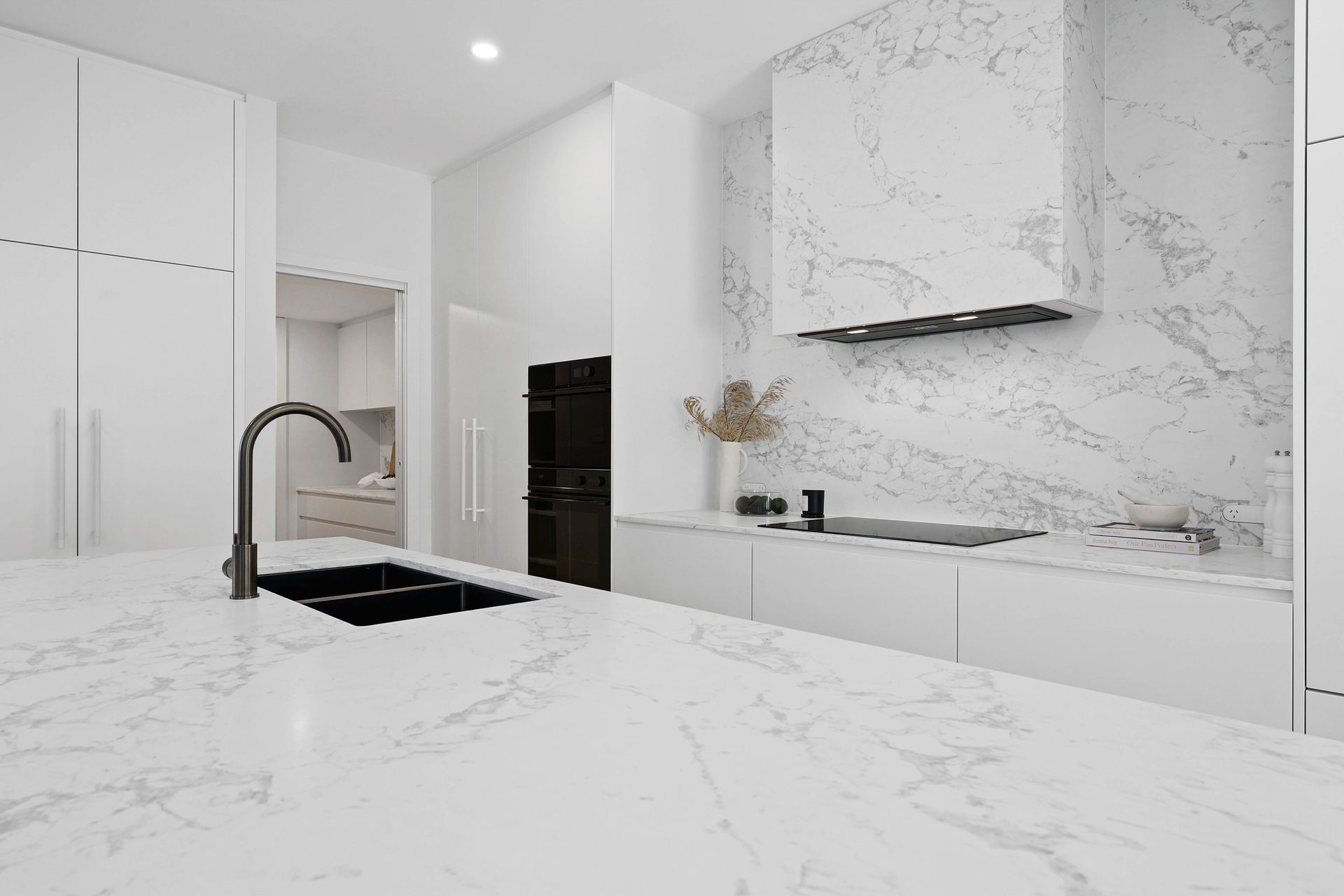 Modern White Kitchen With Marble Countertops — Above & Beyond Interiors in Smeaton Grange, NSW