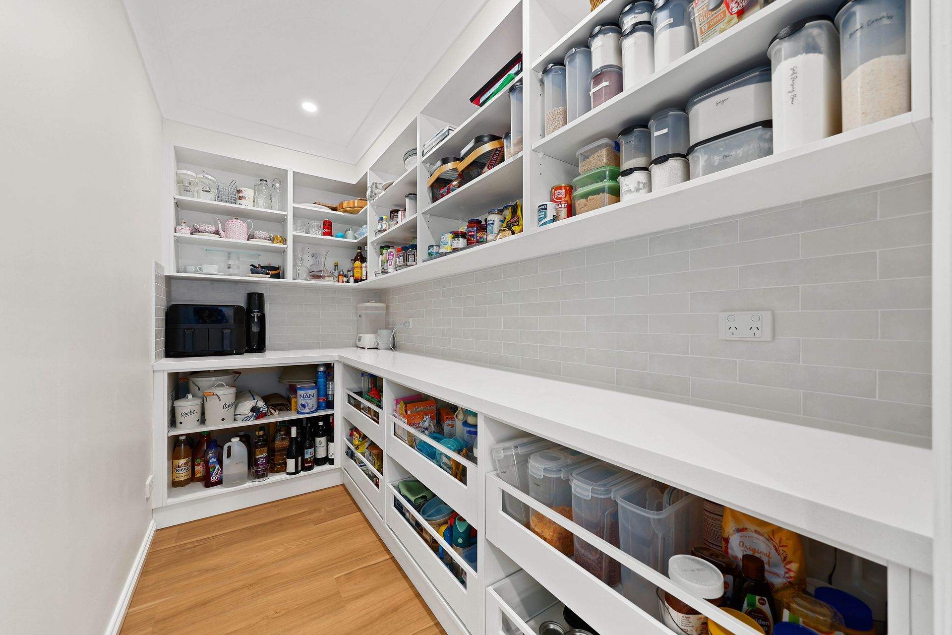Bright Walk-In Pantry with White Shelves — Above & Beyond Interiors in Smeaton Grange, NSW