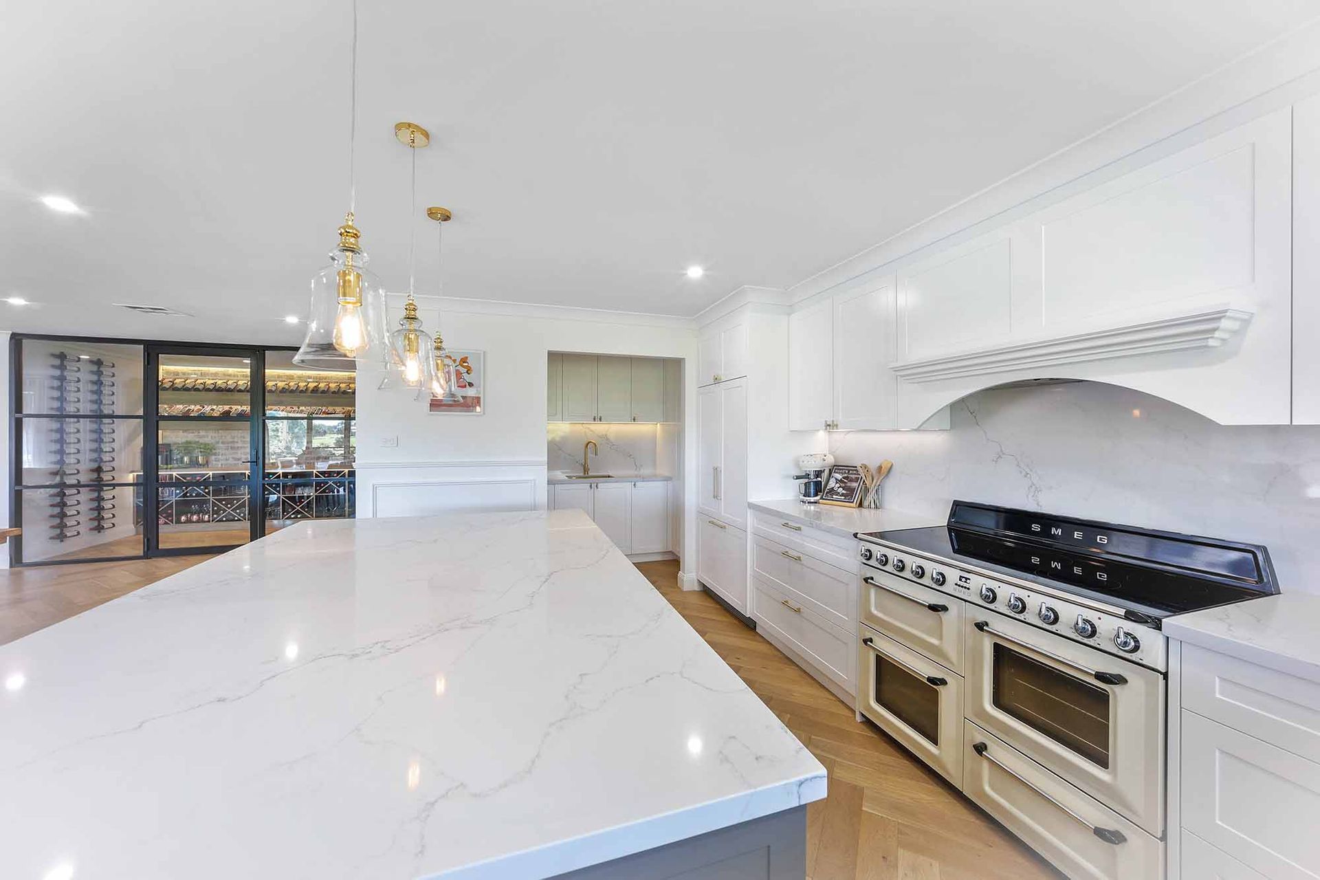 Bright White Kitchen With Marble Island — Above & Beyond Interiors in Smeaton Grange, NSW