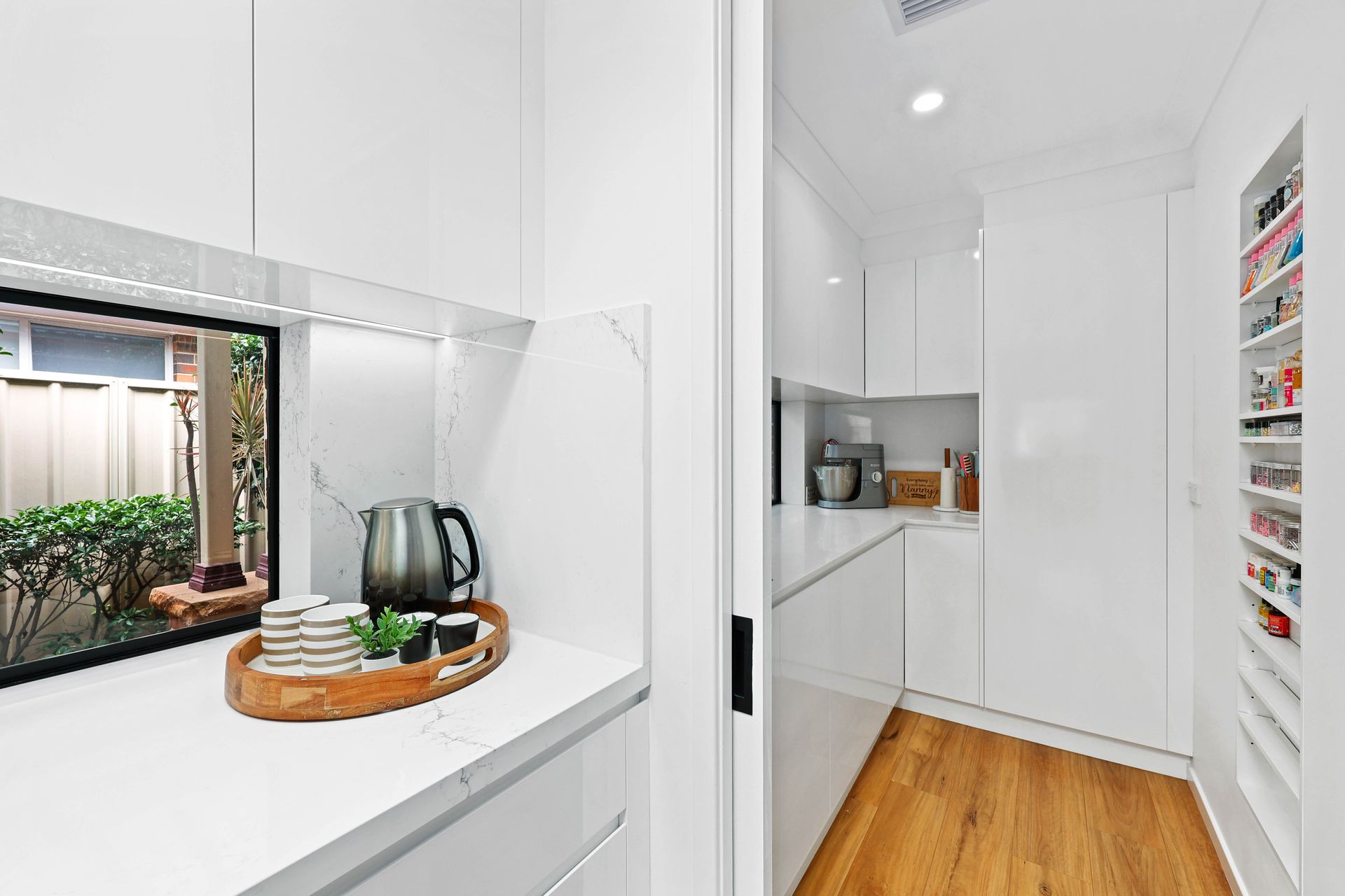 Bright White Kitchen with A Countertop Kettle — Above & Beyond Interiors in Smeaton Grange, NSW