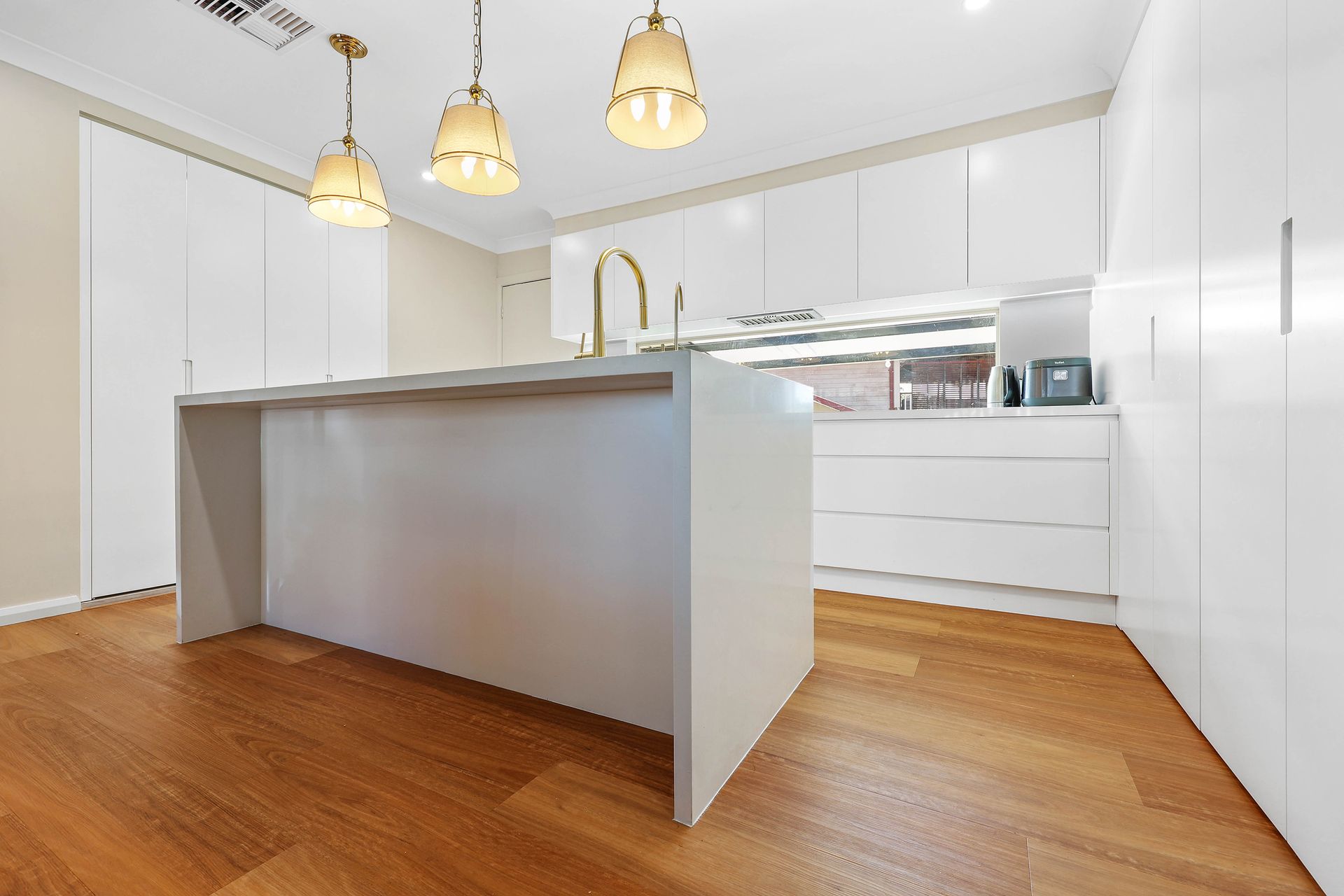 Bright Modern Kitchen With White Cabinets — Above & Beyond Interiors in Smeaton Grange, NSW