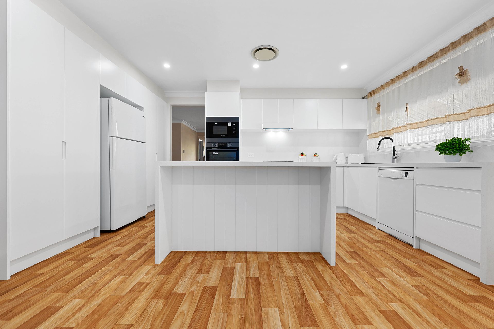 Bright White Modern Kitchen with Island — Above & Beyond Interiors in Smeaton Grange, NSW