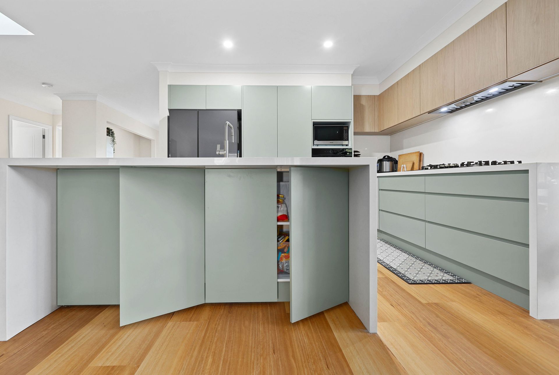 Modern Kitchen with Mint Green Cabinets — Above & Beyond Interiors in Smeaton Grange, NSW