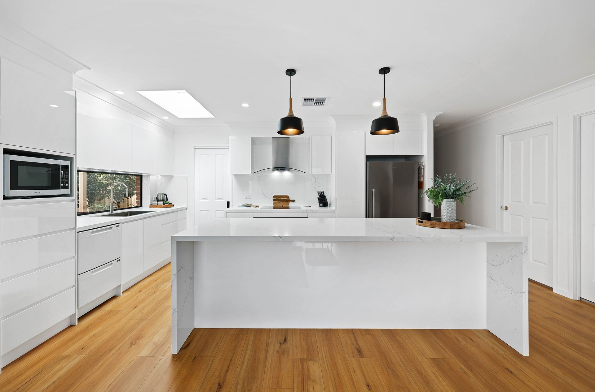 Bright White Modern Kitchen with Island — Above & Beyond Interiors in Smeaton Grange, NSW