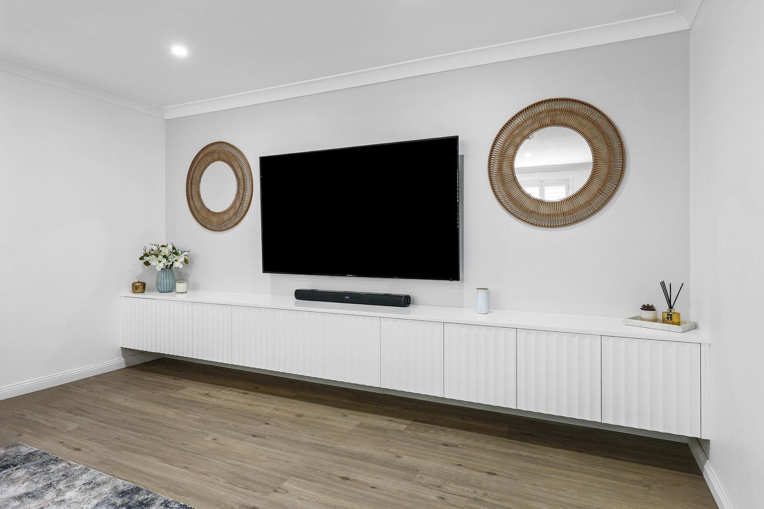 Minimal Living Room With Wall-mounted TV — Above & Beyond Interiors in Smeaton Grange, NSW
