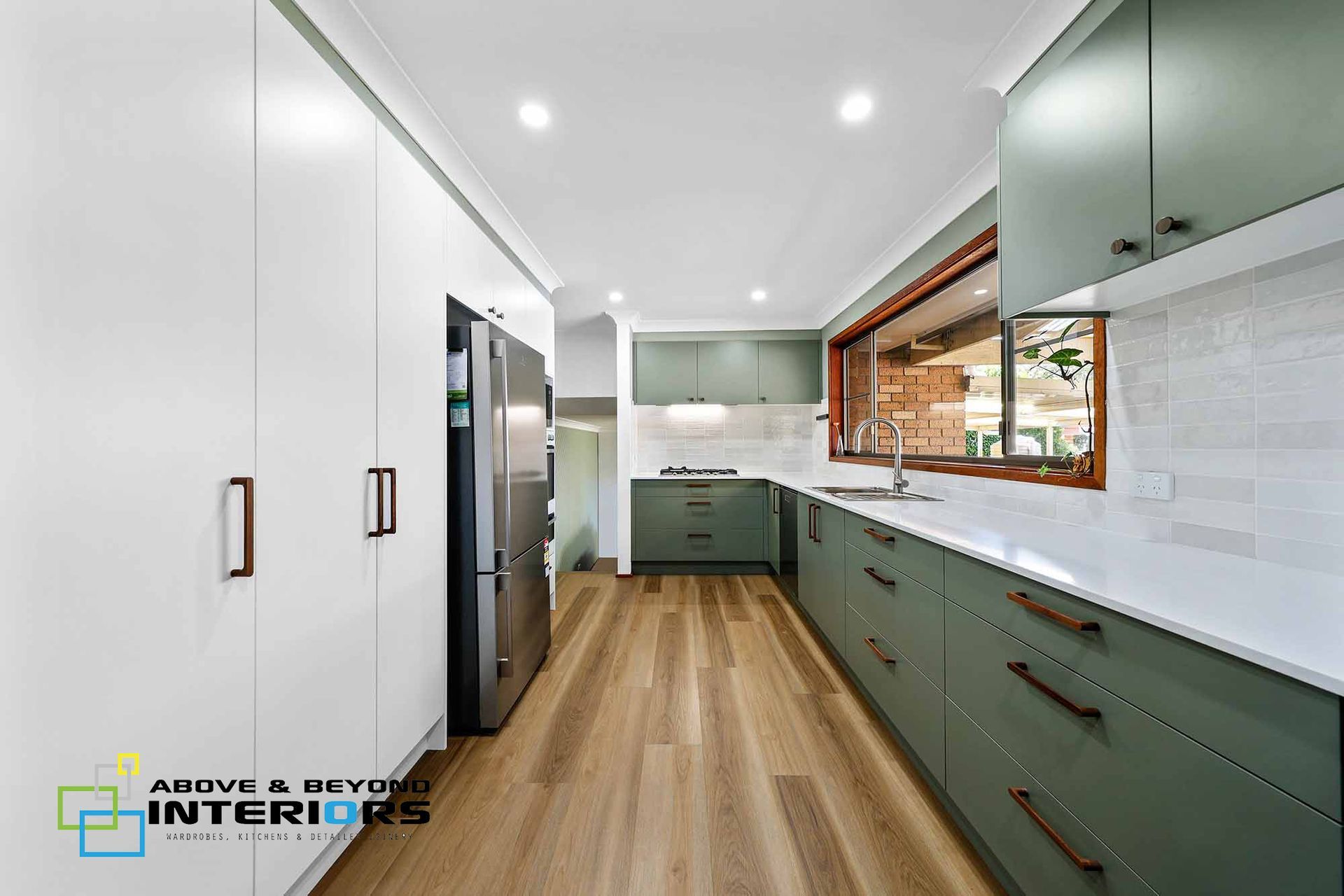 Modern Kitchen with White Cabinets, and Large Window — Above & Beyond Interiors in Smeaton Grange, NSW